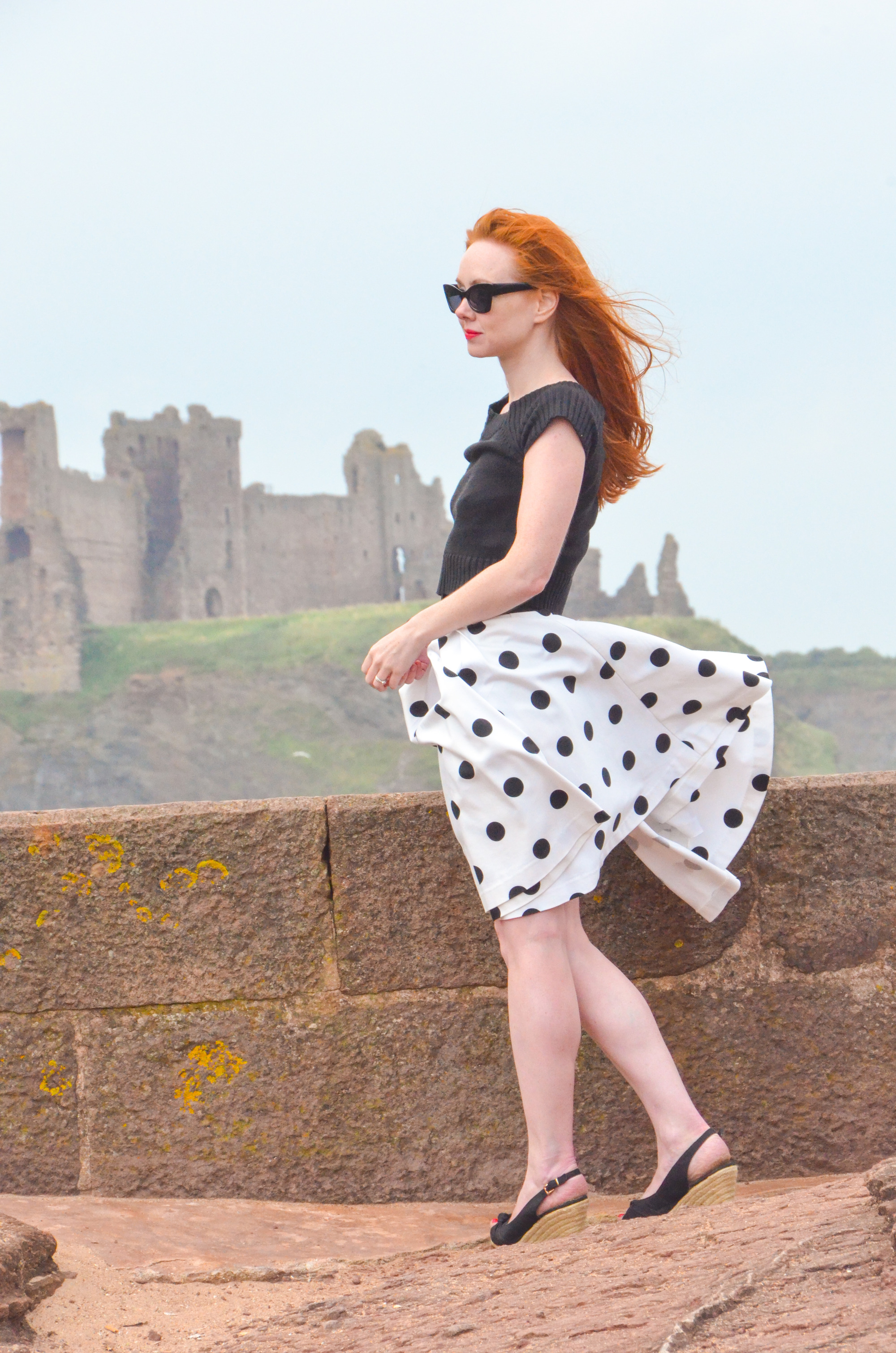 black and white polka dot skirt on a windy day