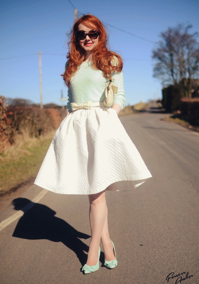 green sweater and 50s style full skirt