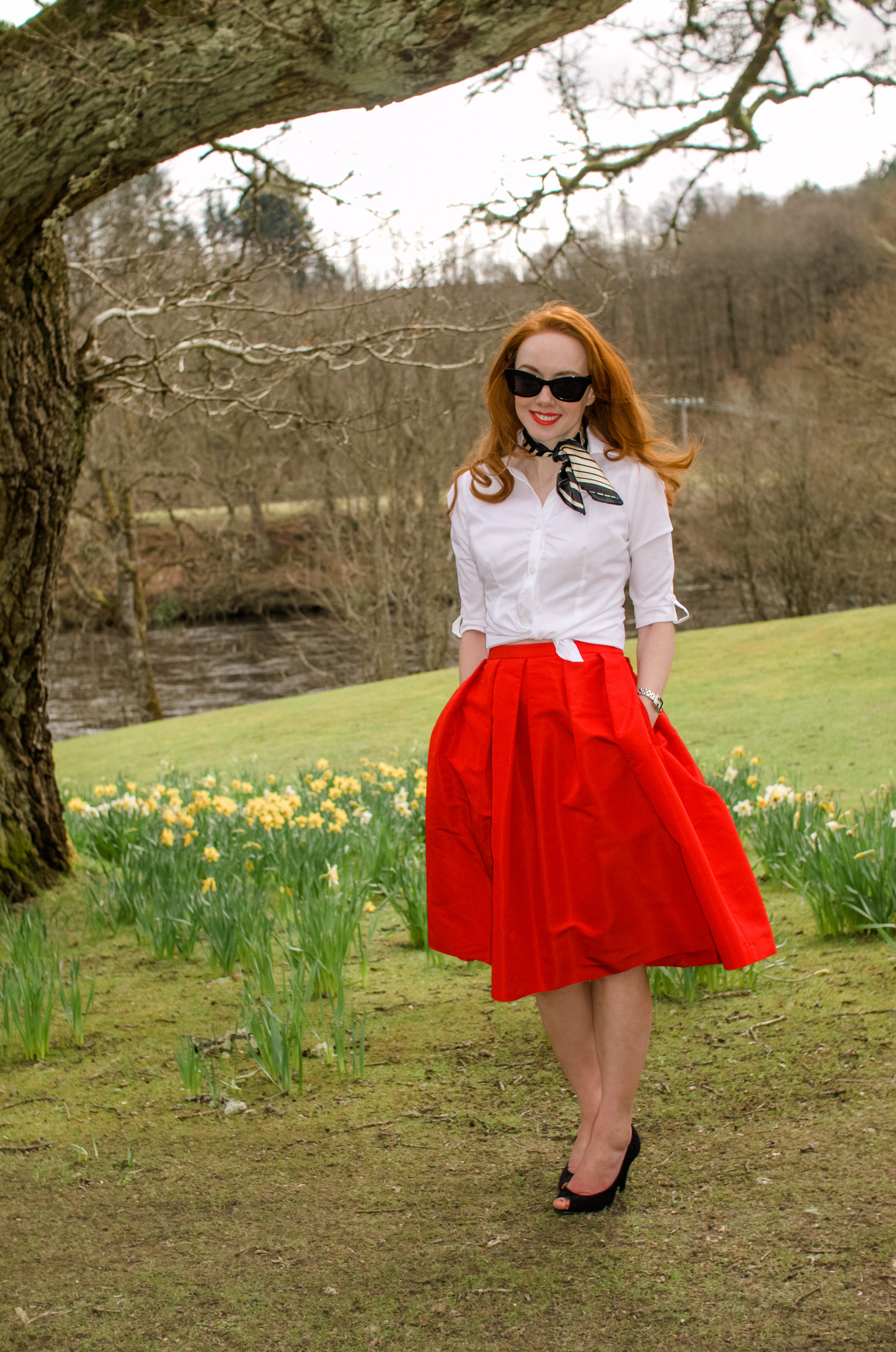 retro inspired outfit featuring full red skirt and white knotted shirt