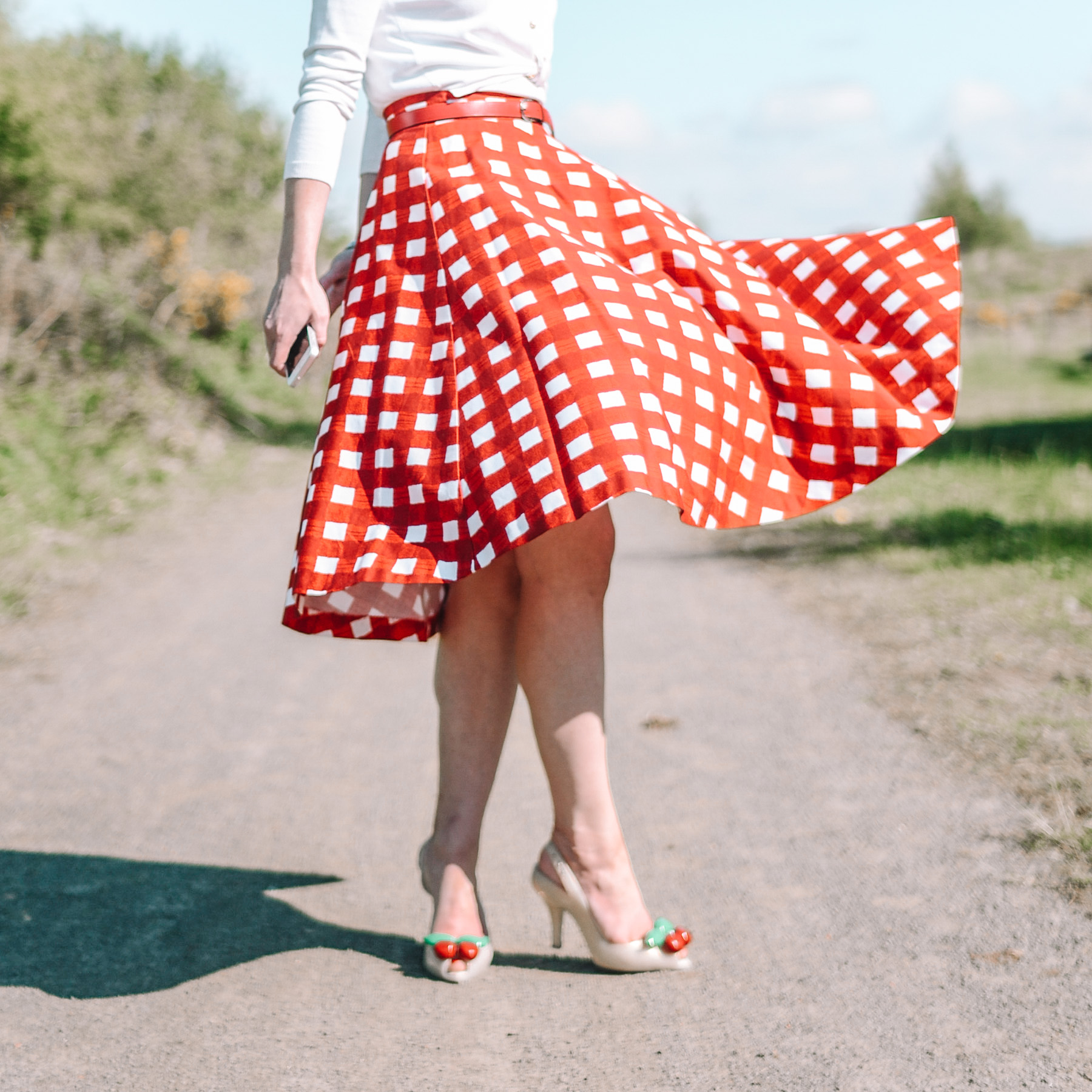 retro-inspired outfit featuring red gingham circle skirt and cherry cardigan