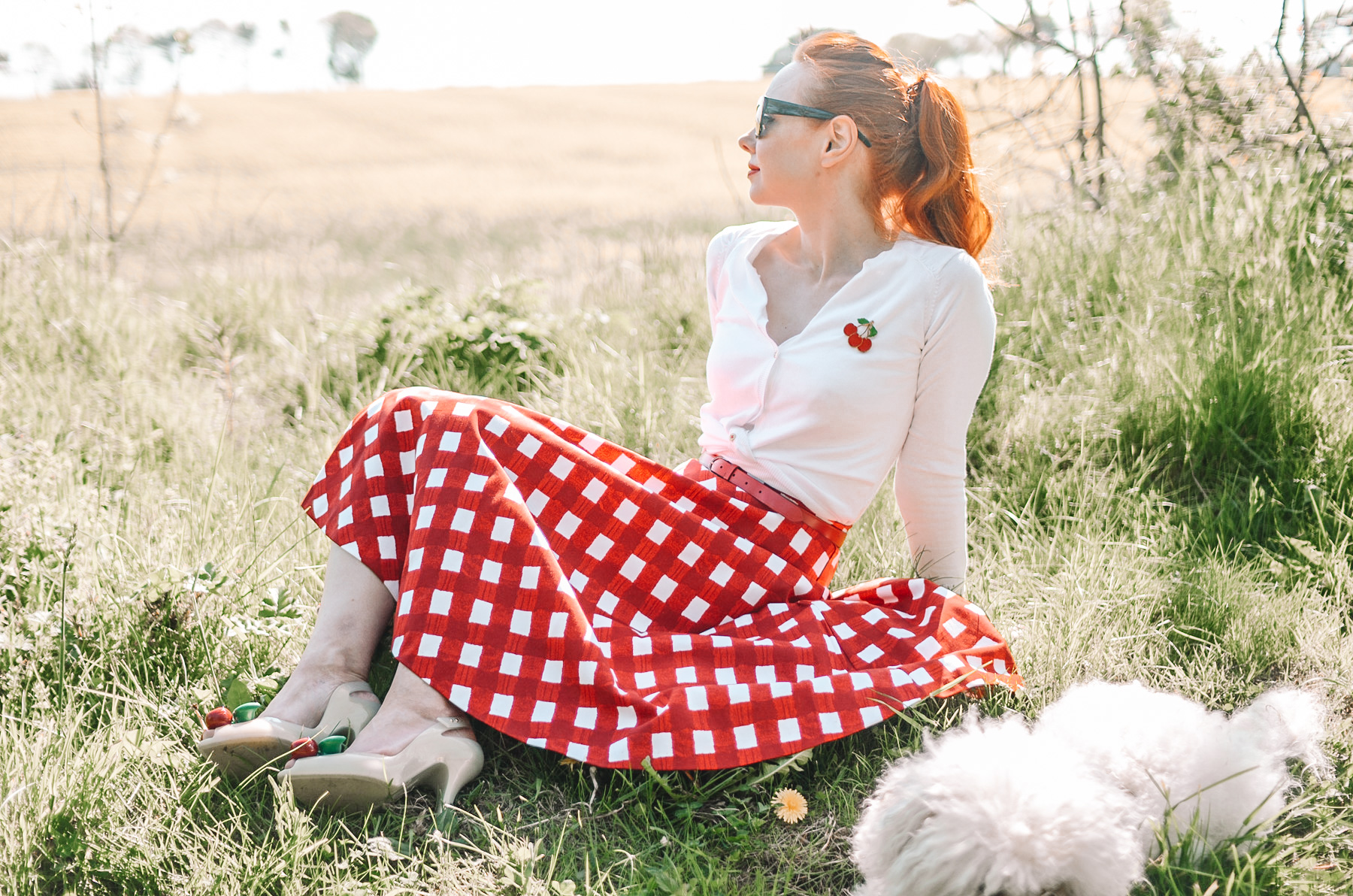 retro-inspired outfit featuring red gingham circle skirt and cherry cardigan
