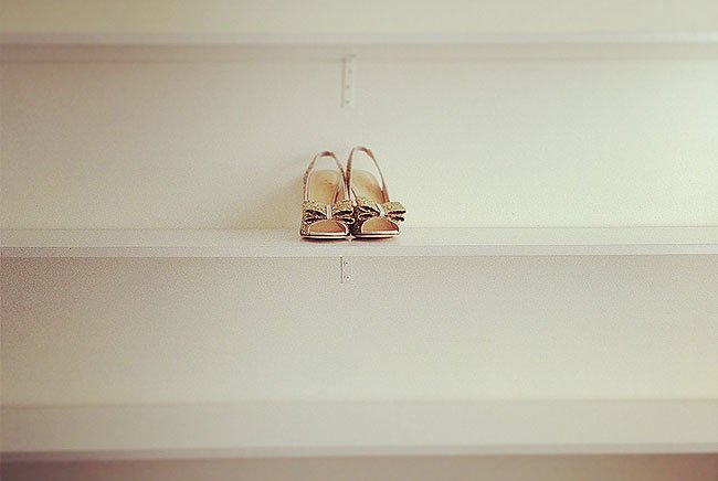 gold shoes on empty shelf