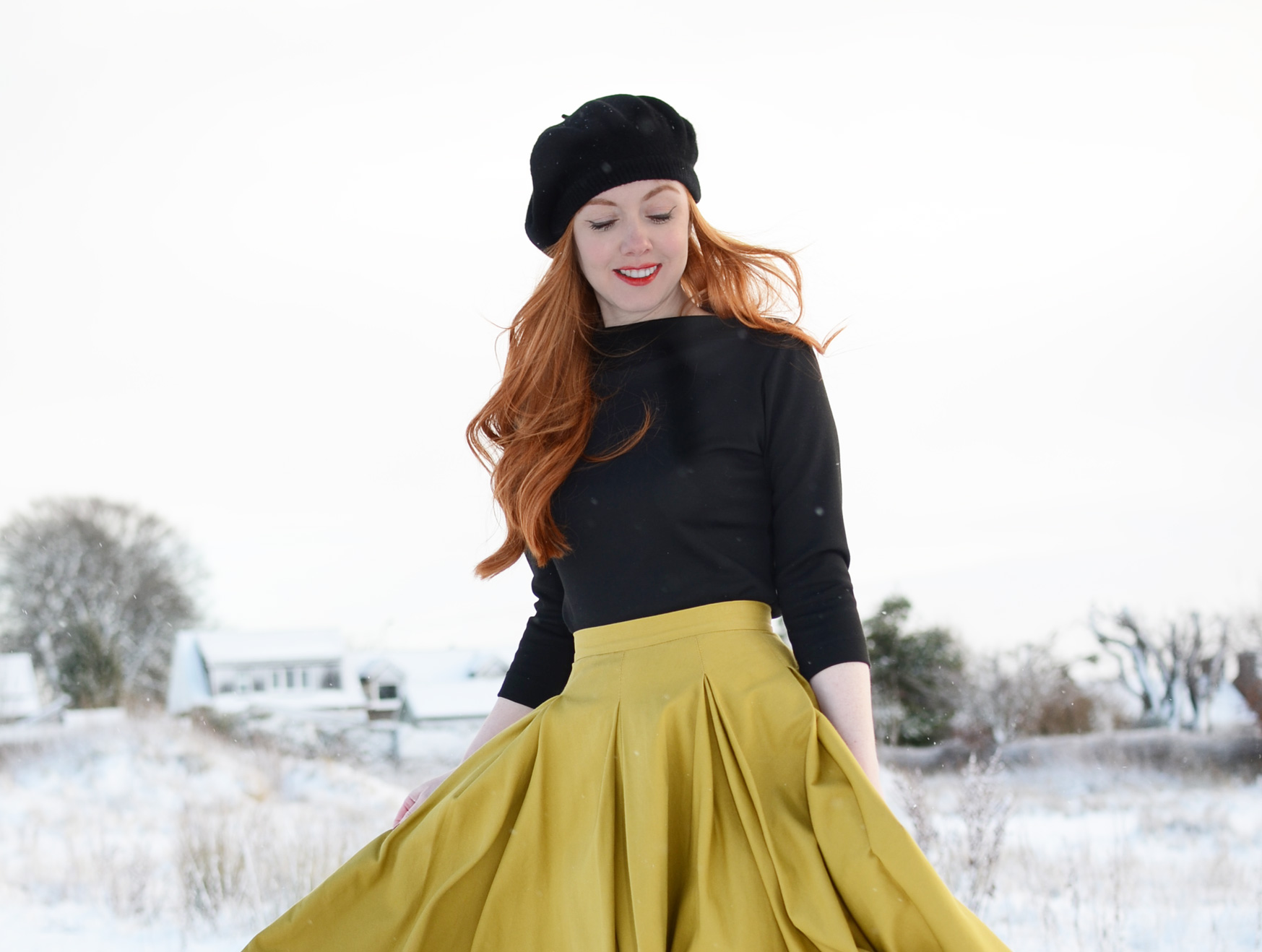 redhead in black beret and yellow skirt