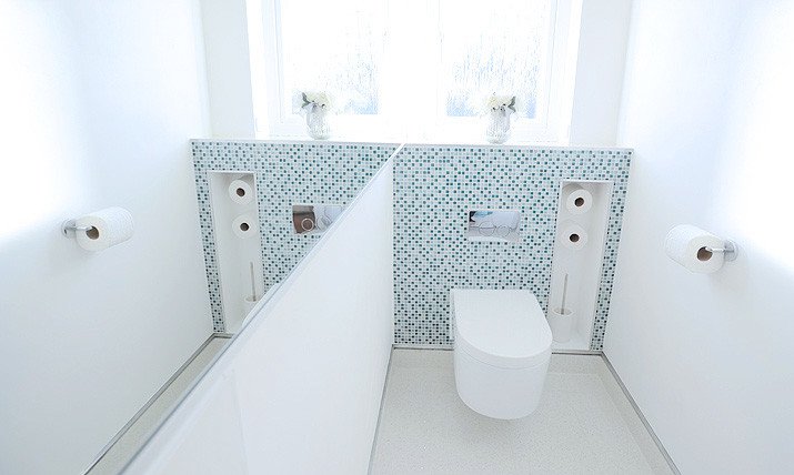 white powder room with green mosaic tile