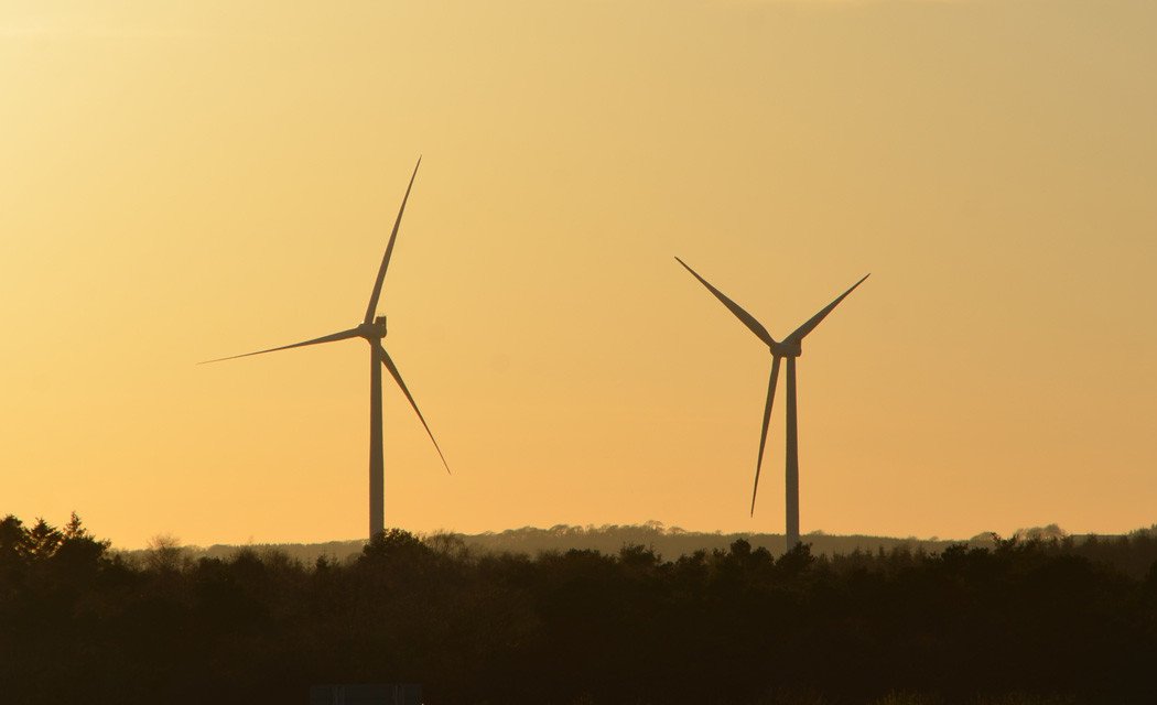 wind turbines against the sunset