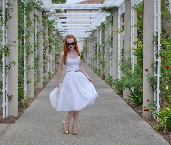 all-white outfit with gold shoes and belt