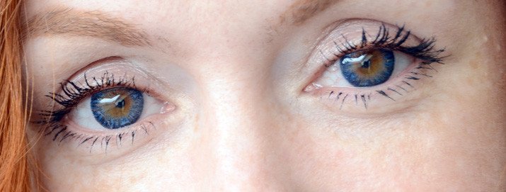 closeup of blue contact lenses in brown eyes