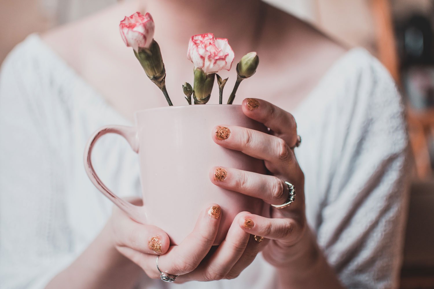 flowers in pink mug