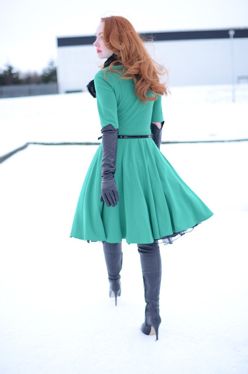 green fit and flare dress with over-the-knee boots