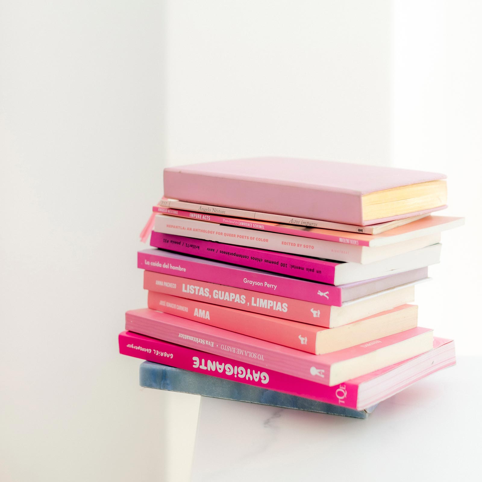pile of pink books on a white table