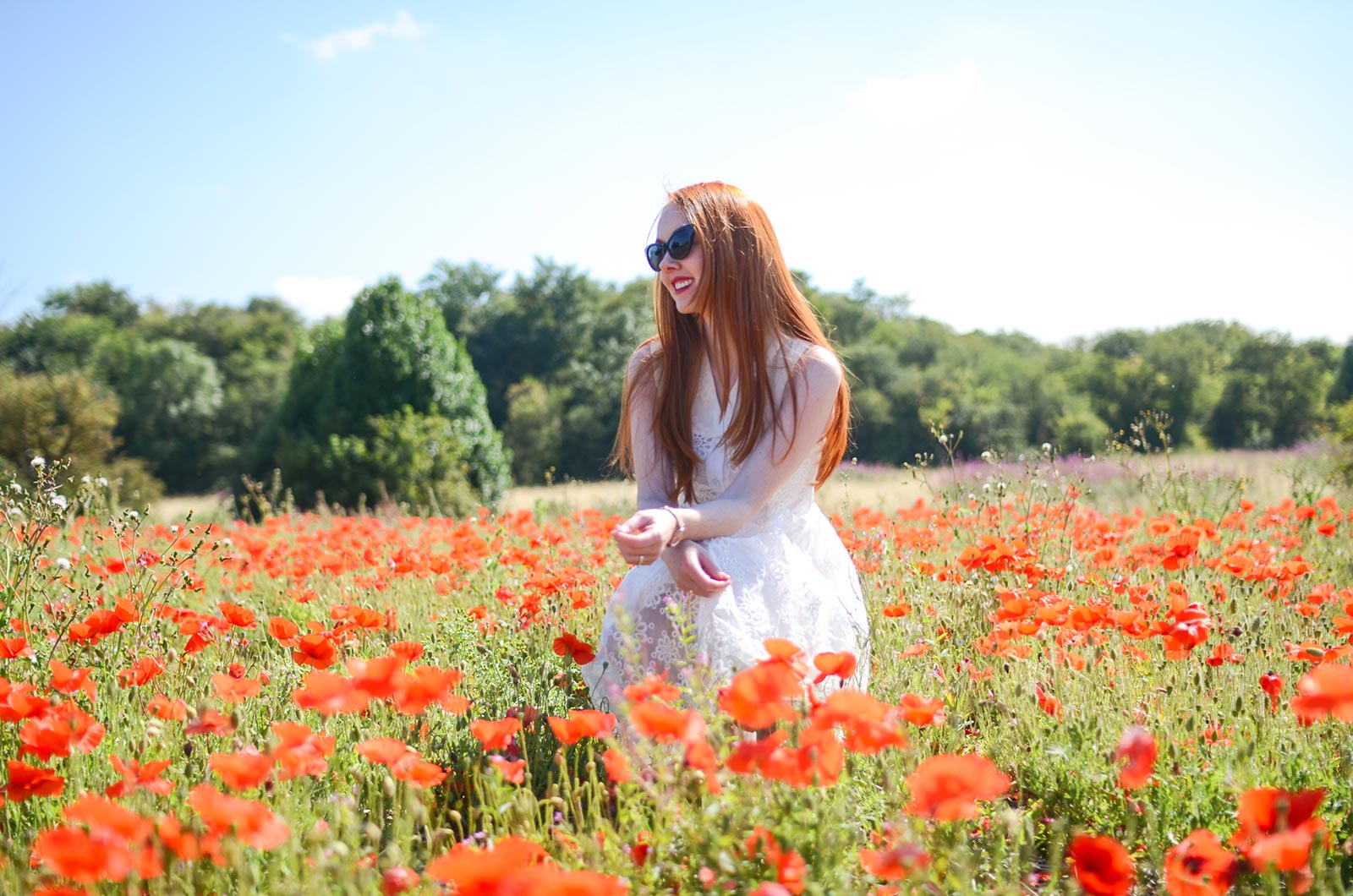 fashion blogger in field of poppies