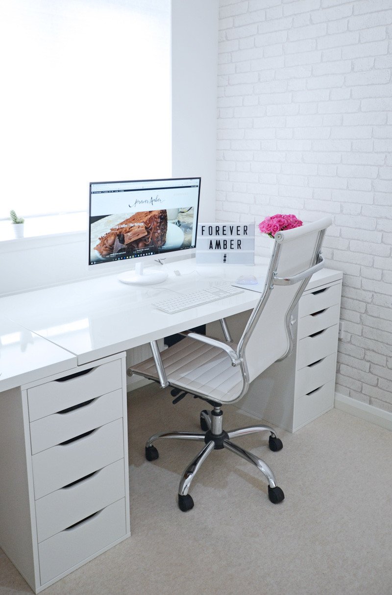 all white office with exposed brick wallpaper