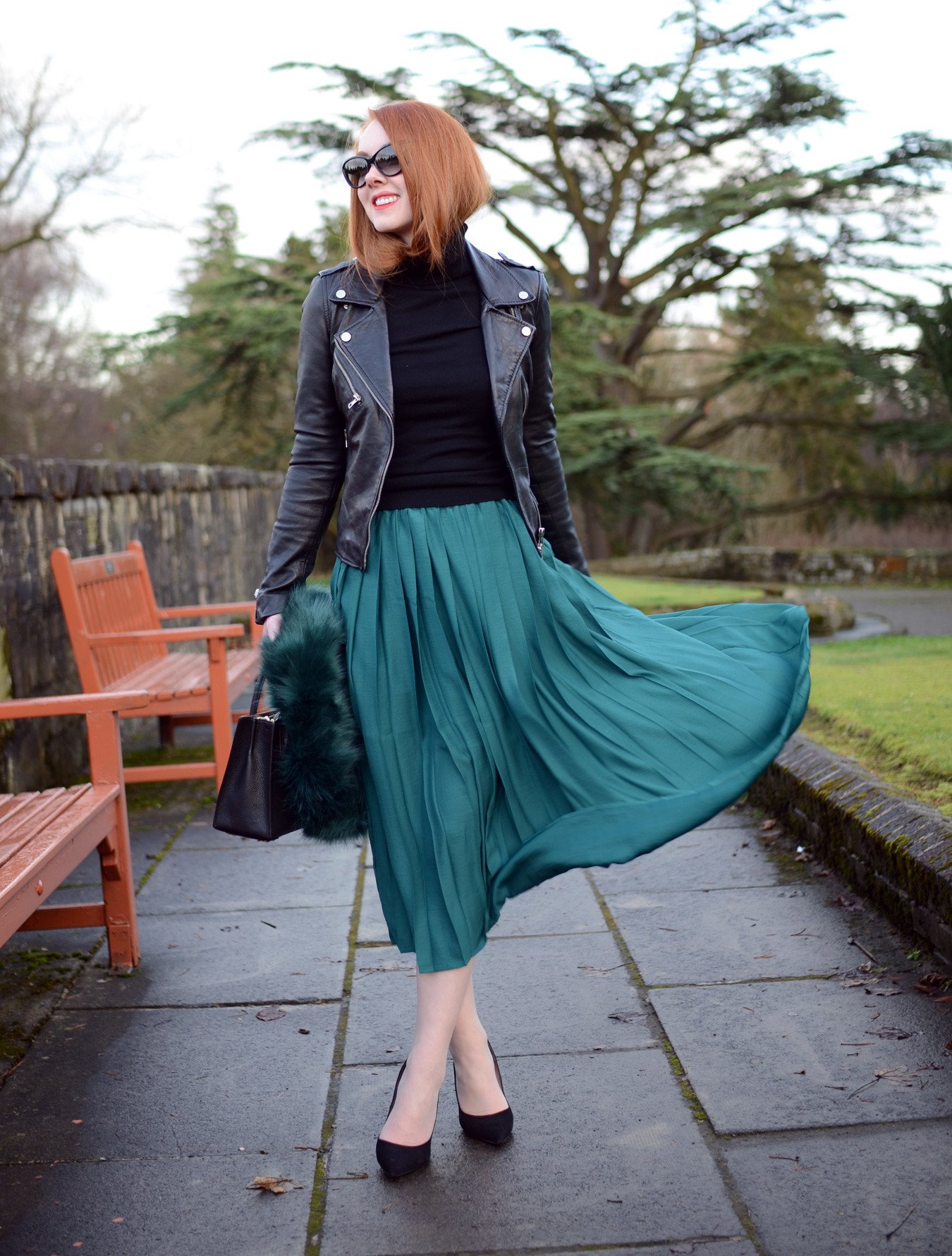 green pleated skirt with black leather biker jacket