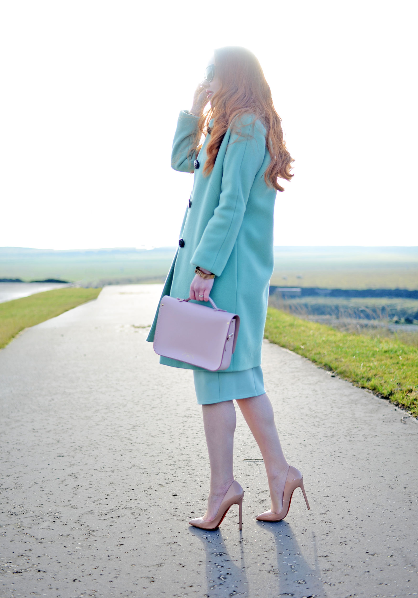 mint green winter coat and high heels