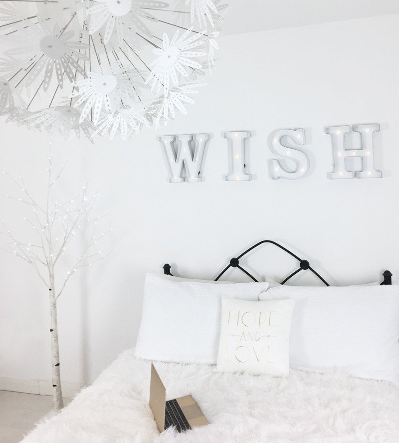 all-white bedroom with white LED tree light and WISH sign