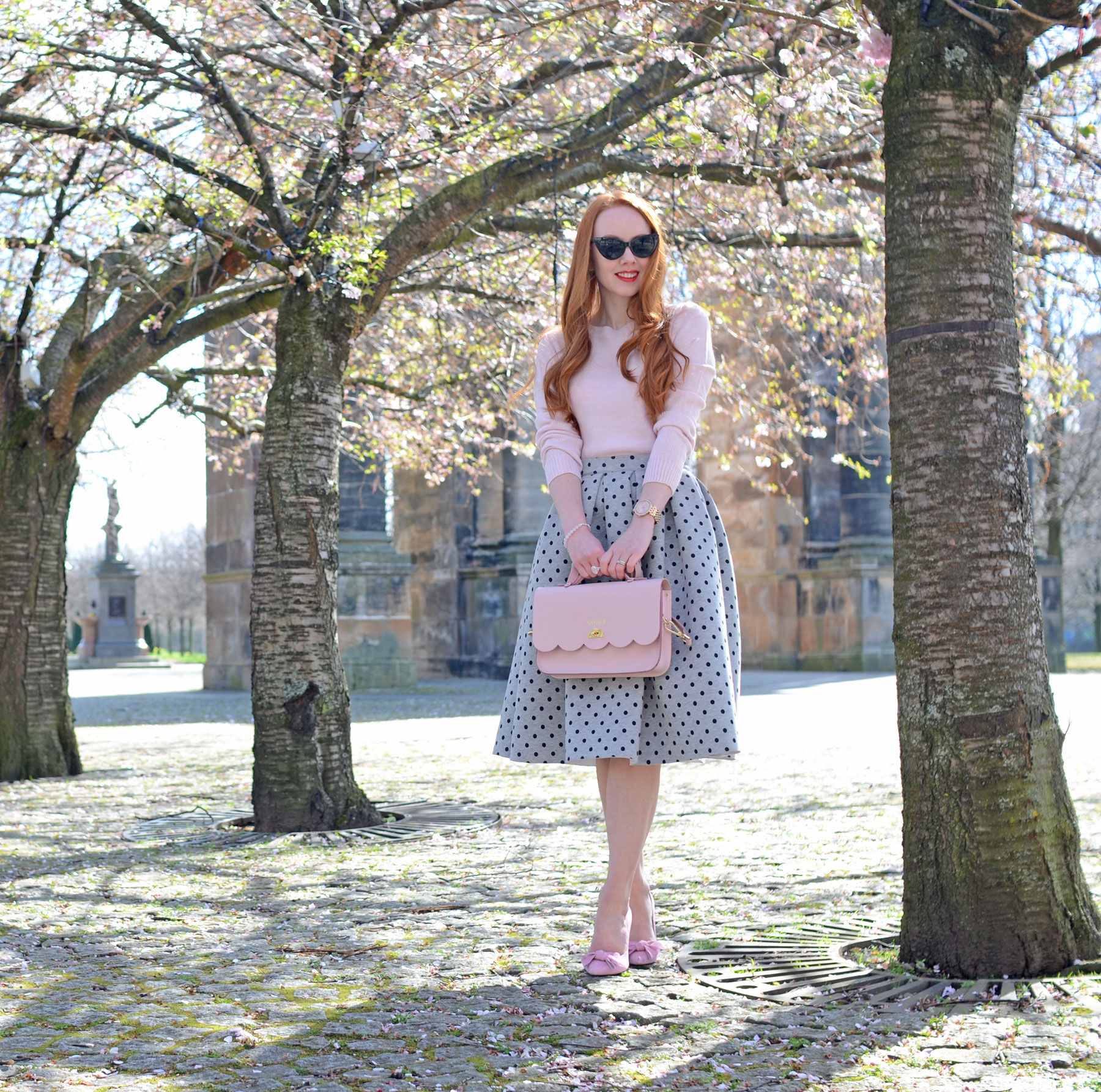 grey polka dot midi skirt with pink sweater and pink shoes