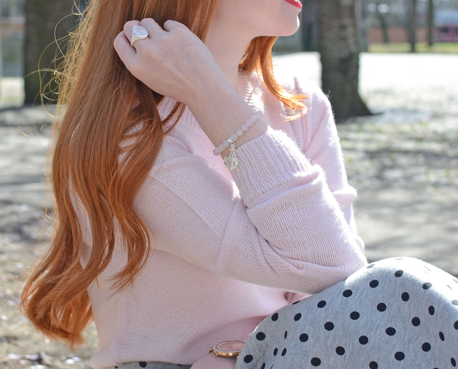 pink sweater with matching pink bracelet