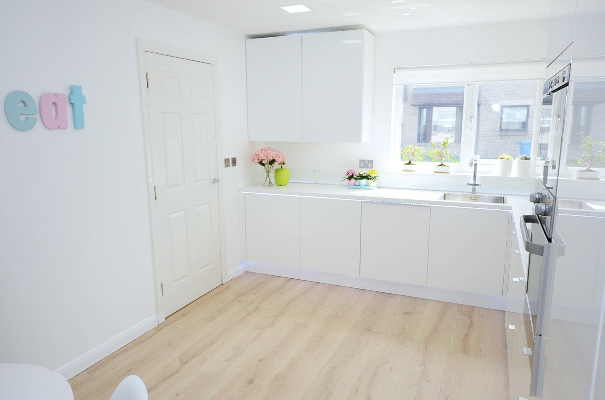 All white Scandanavian-style kitchen with pale wood floors