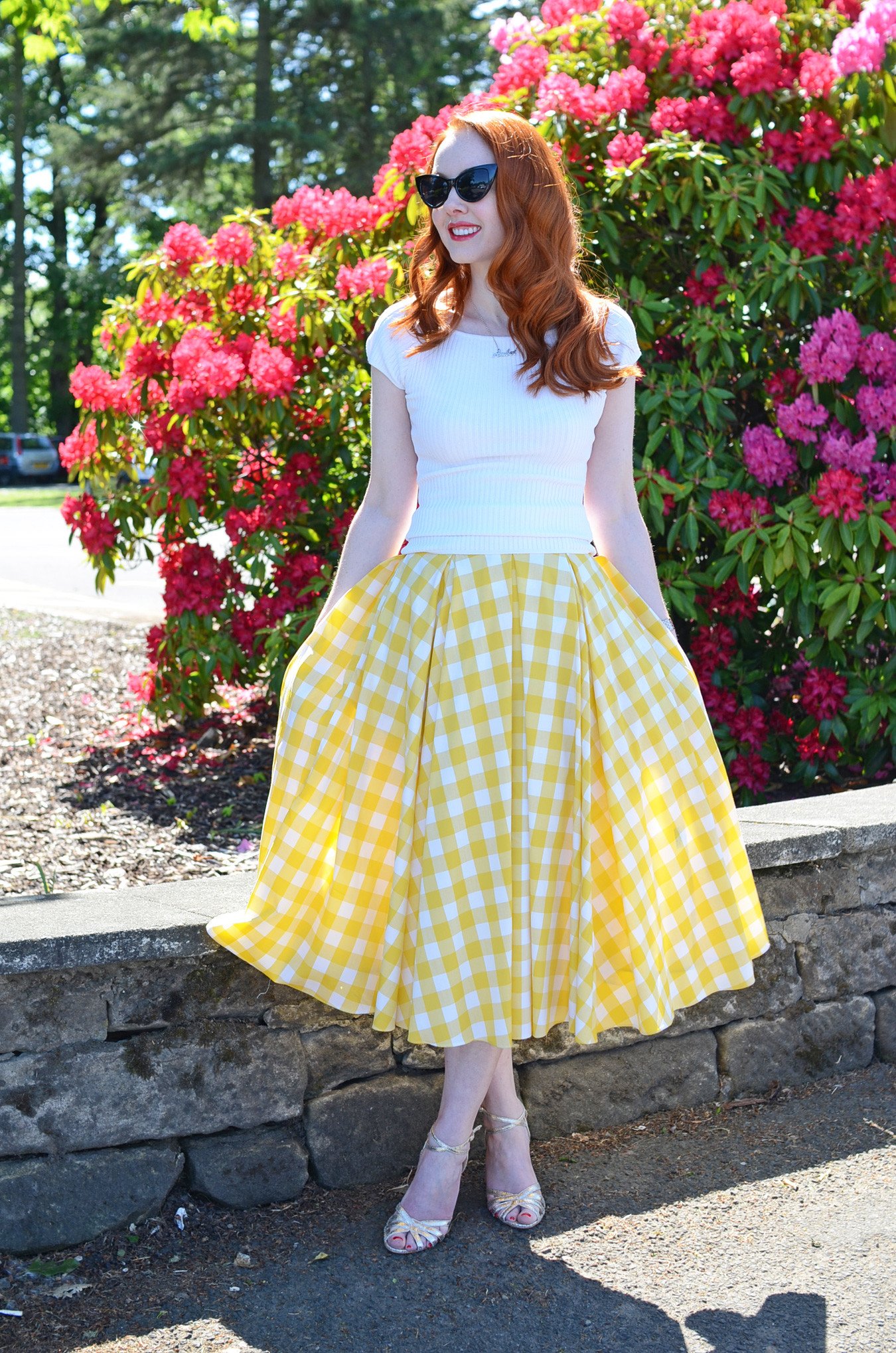 retro-inspired summer outfit: yellow gingham skirt with gold sandals