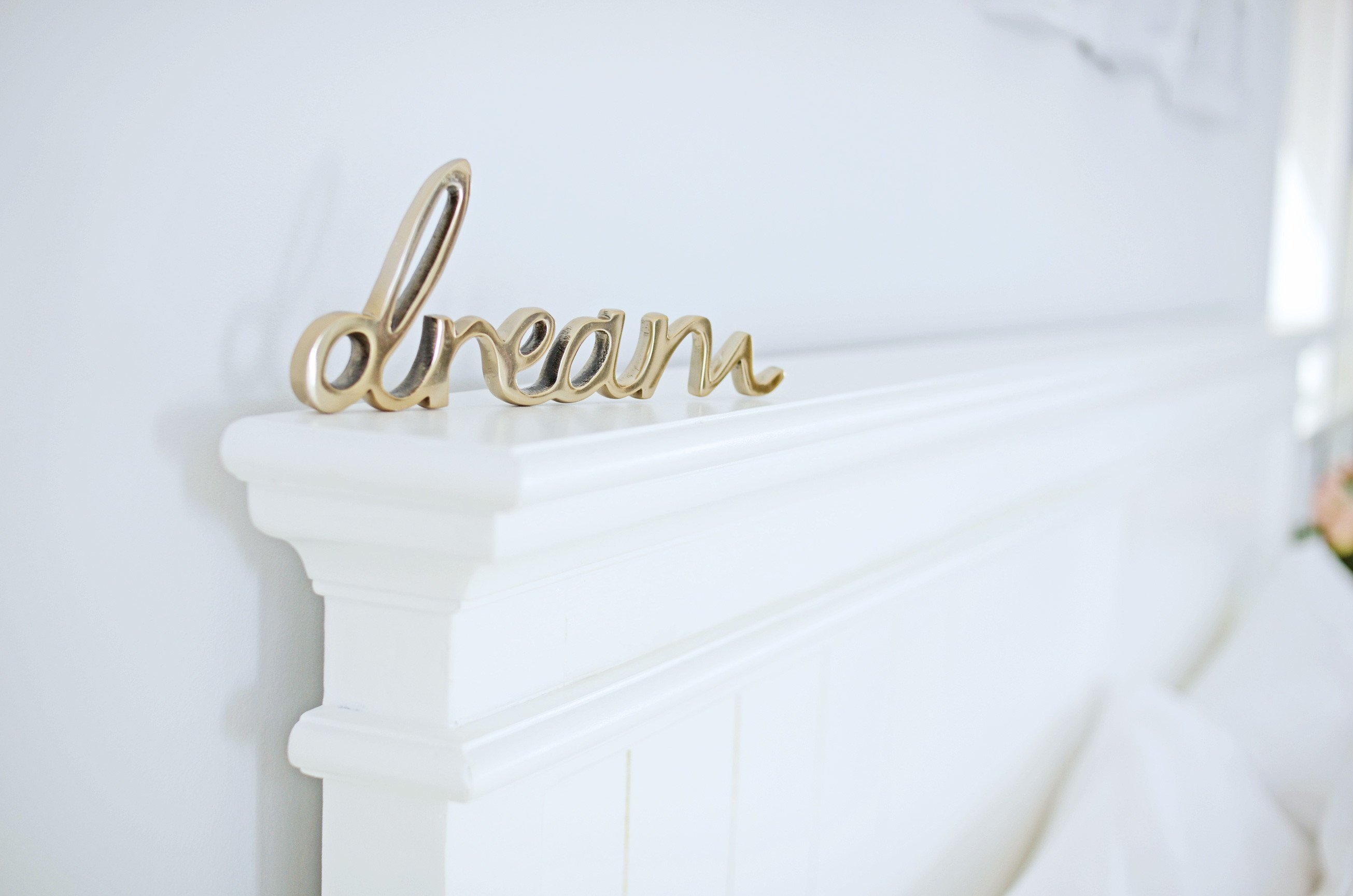 'dream' sign on wooden bedstead