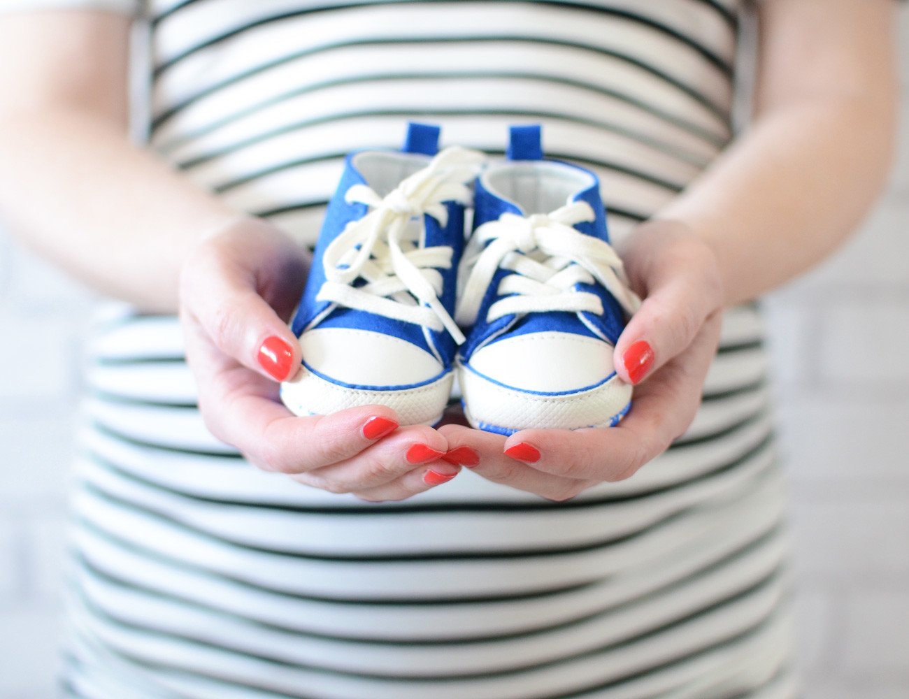 gender reveal: blue baby shoes