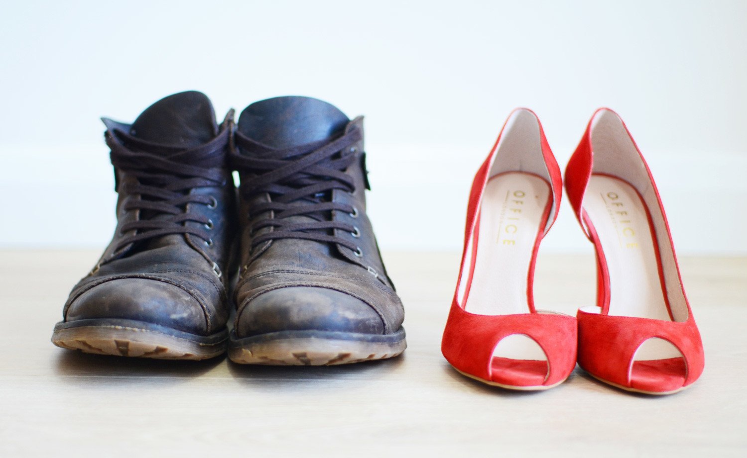his and hers shoes: red high heels and black boots