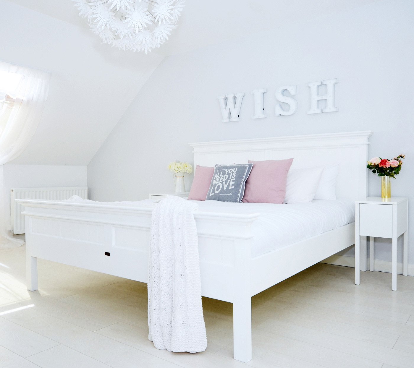 New England Superking bed with WISH sign and pink and grey cushions