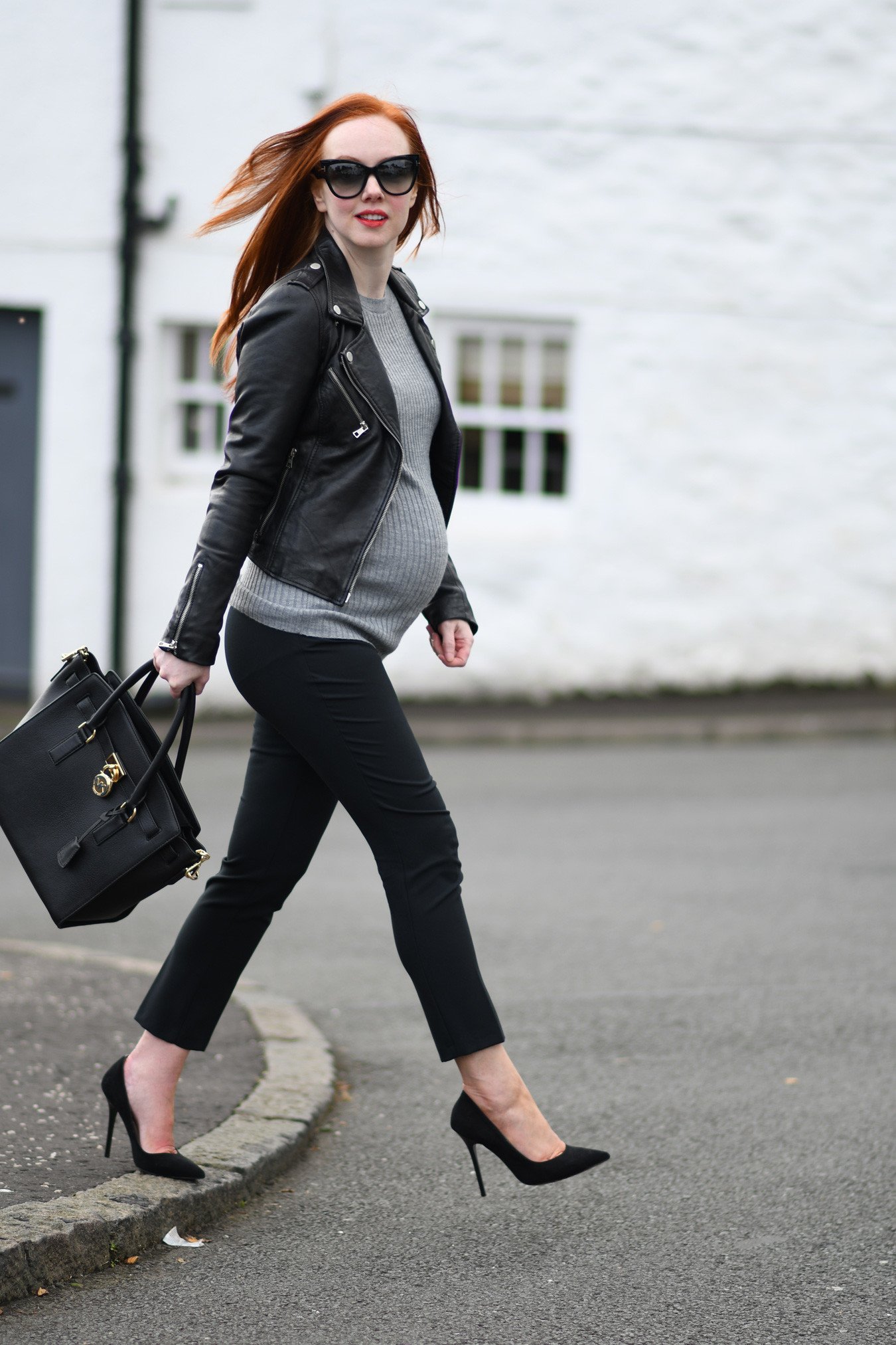 maternity style: black cropped trousers with leather biker jacket and high heels