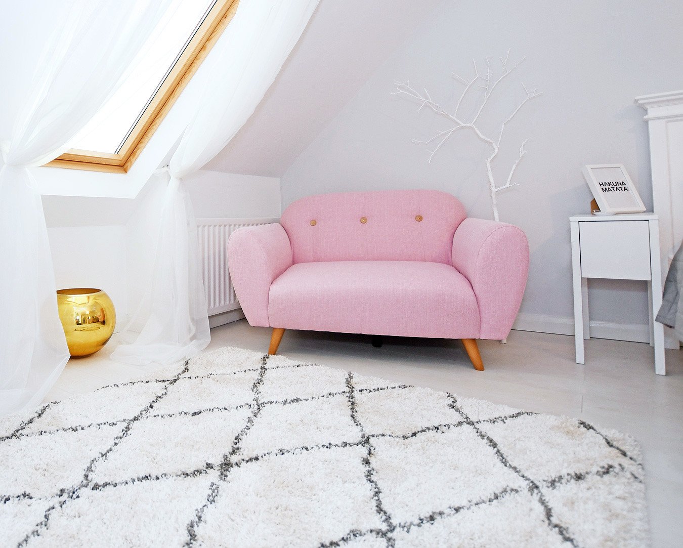 pink two-seater sofa in bedroom