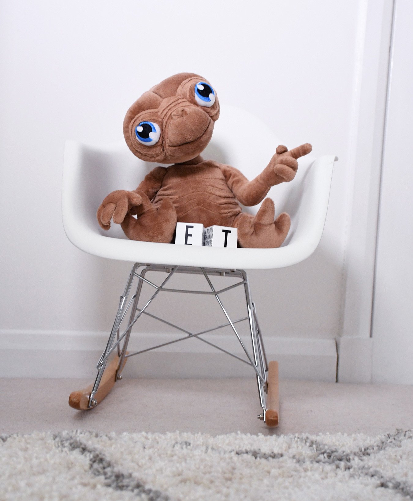 plush E.T toy on mini Eames rocking chair