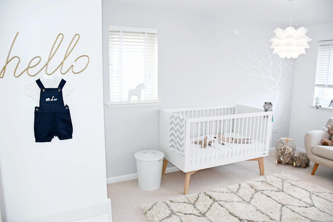 Neutral nursery with tree decal on grey wall