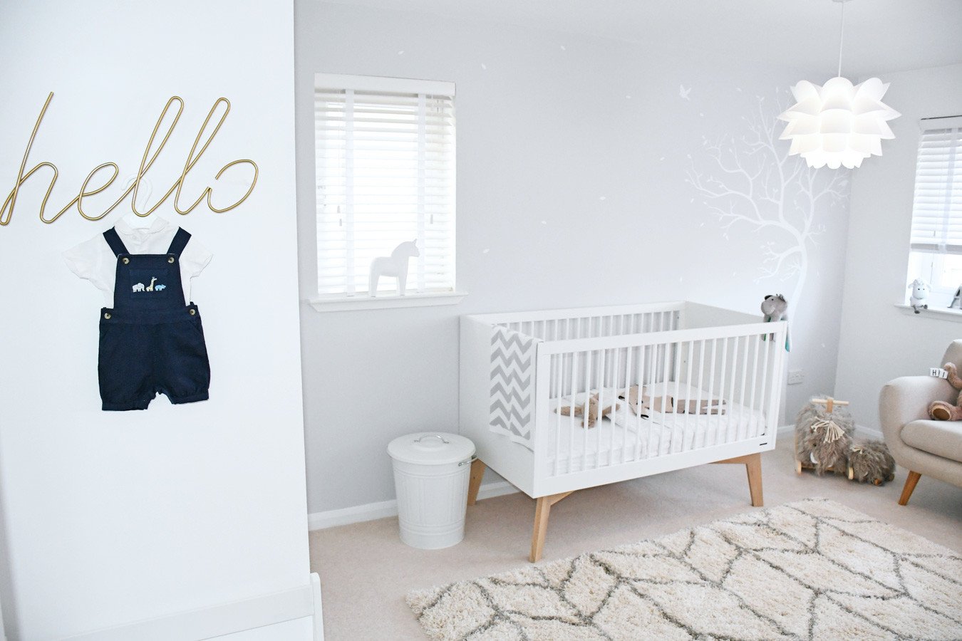 neutral nursery with gold 'hello' sign