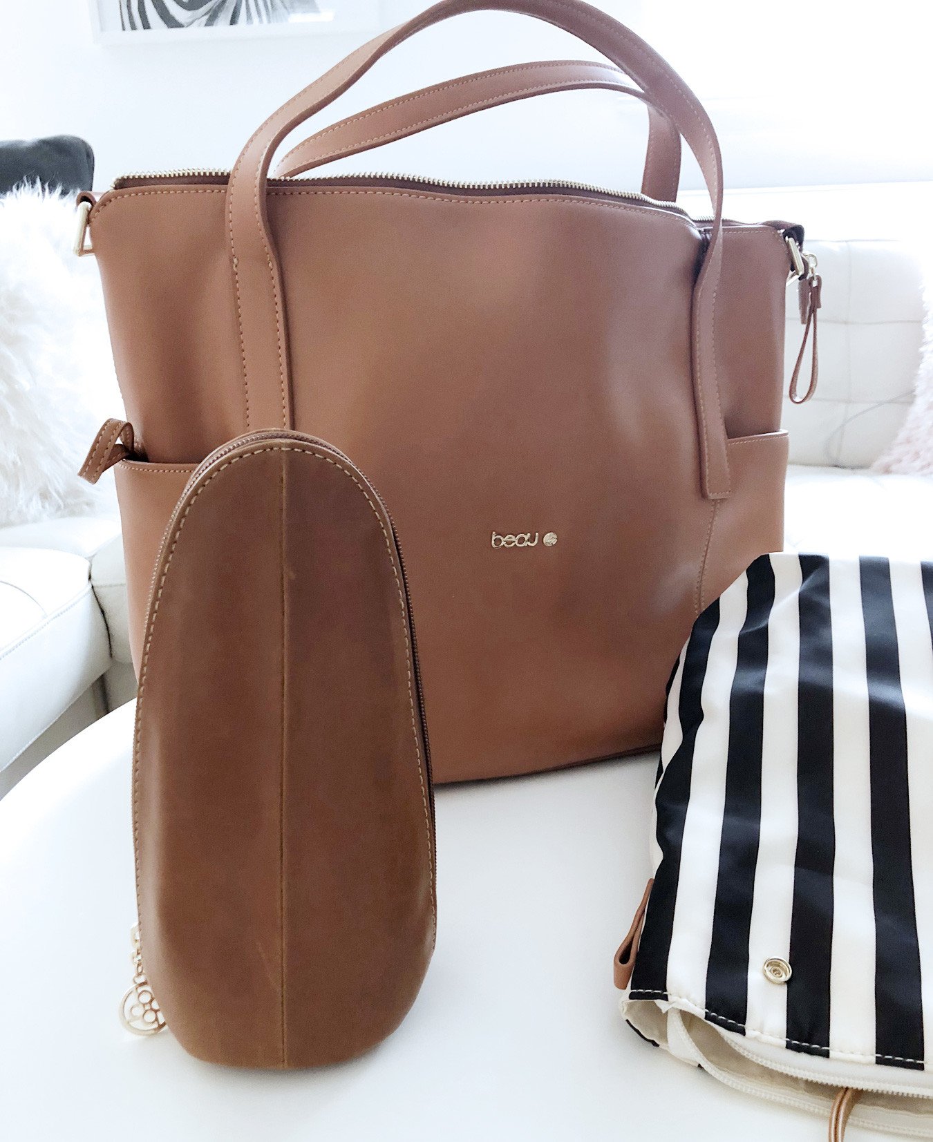 stylish changing bag in tan leather with accessories