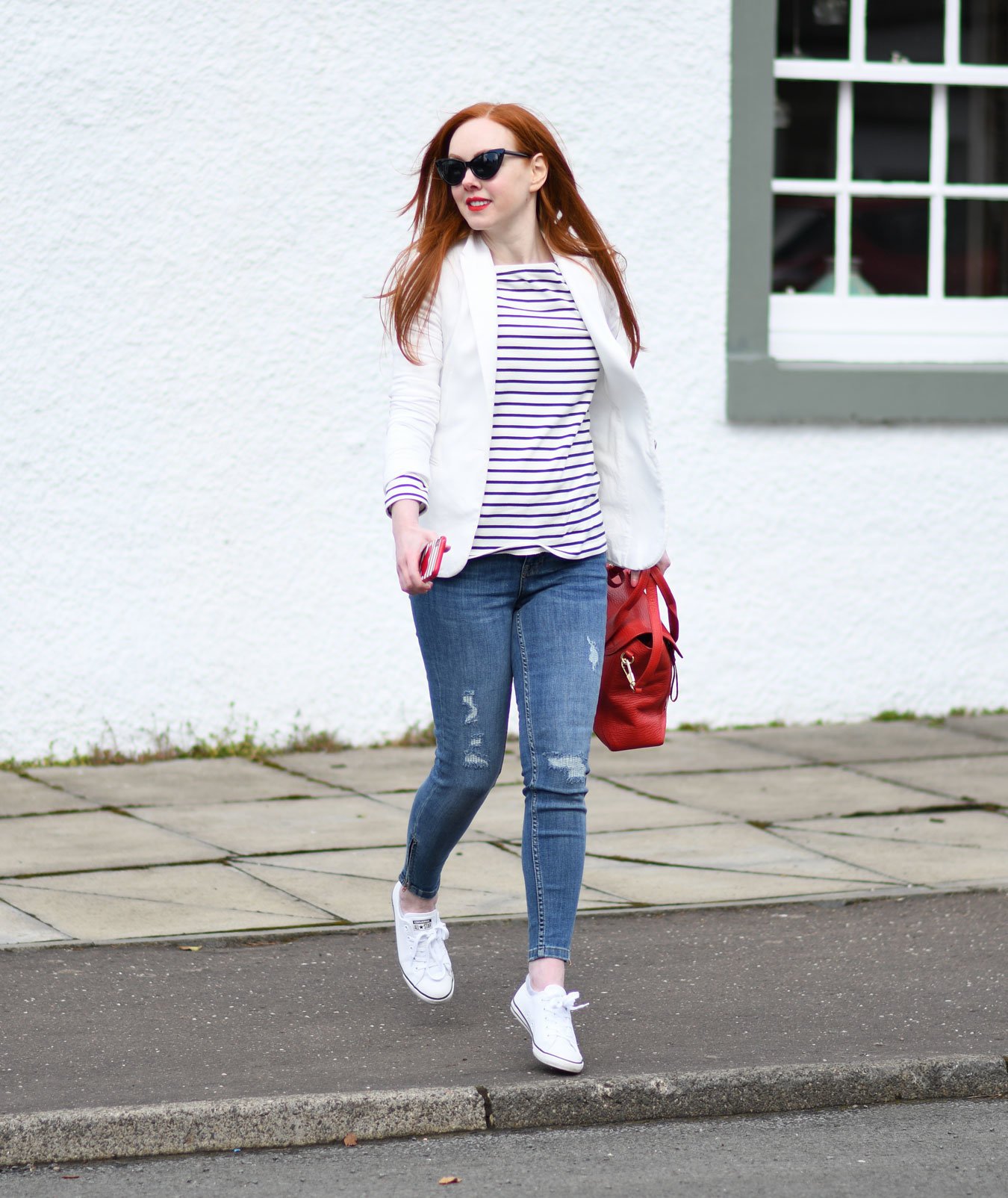 classic casual outfit: blue jeans with Breton top, white blazer and sneakers
