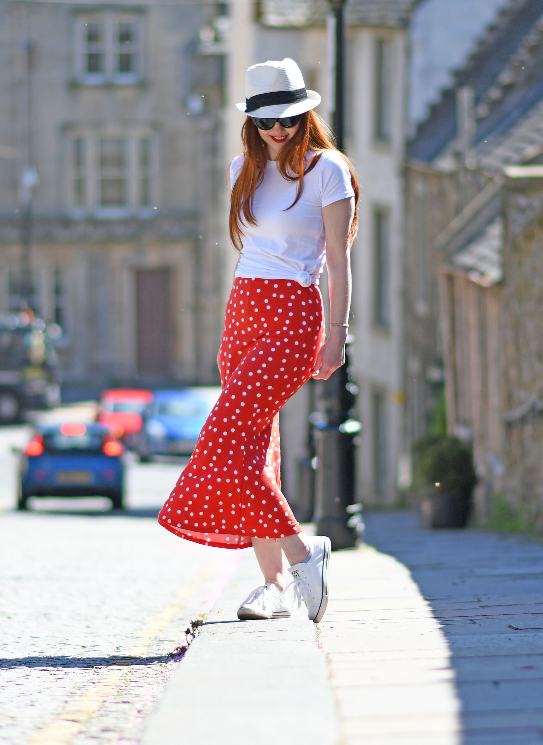 red polka dot skirt with white t-shirt and Converse sneakers