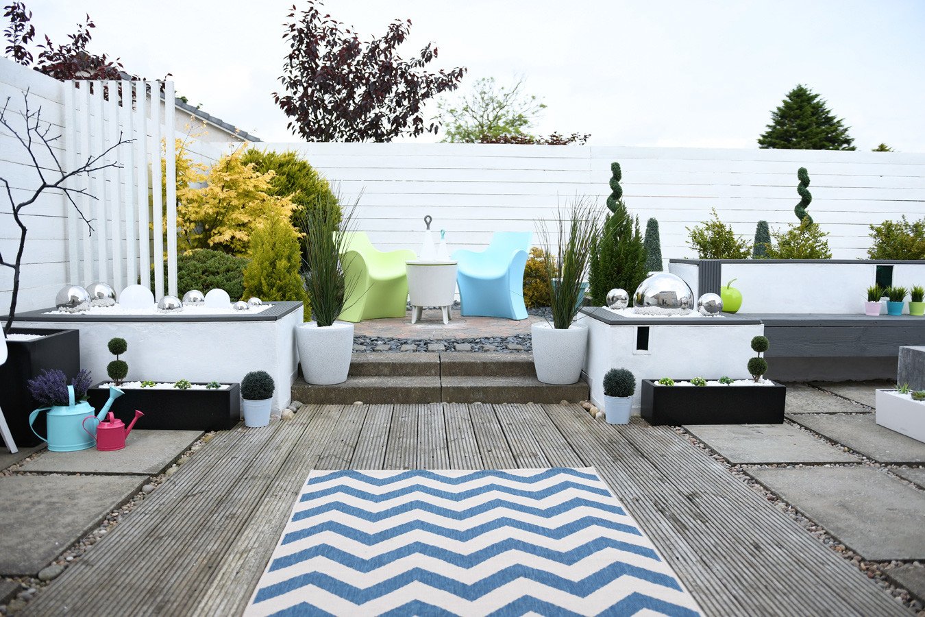 modern garden with statement chairs and outdoor rug