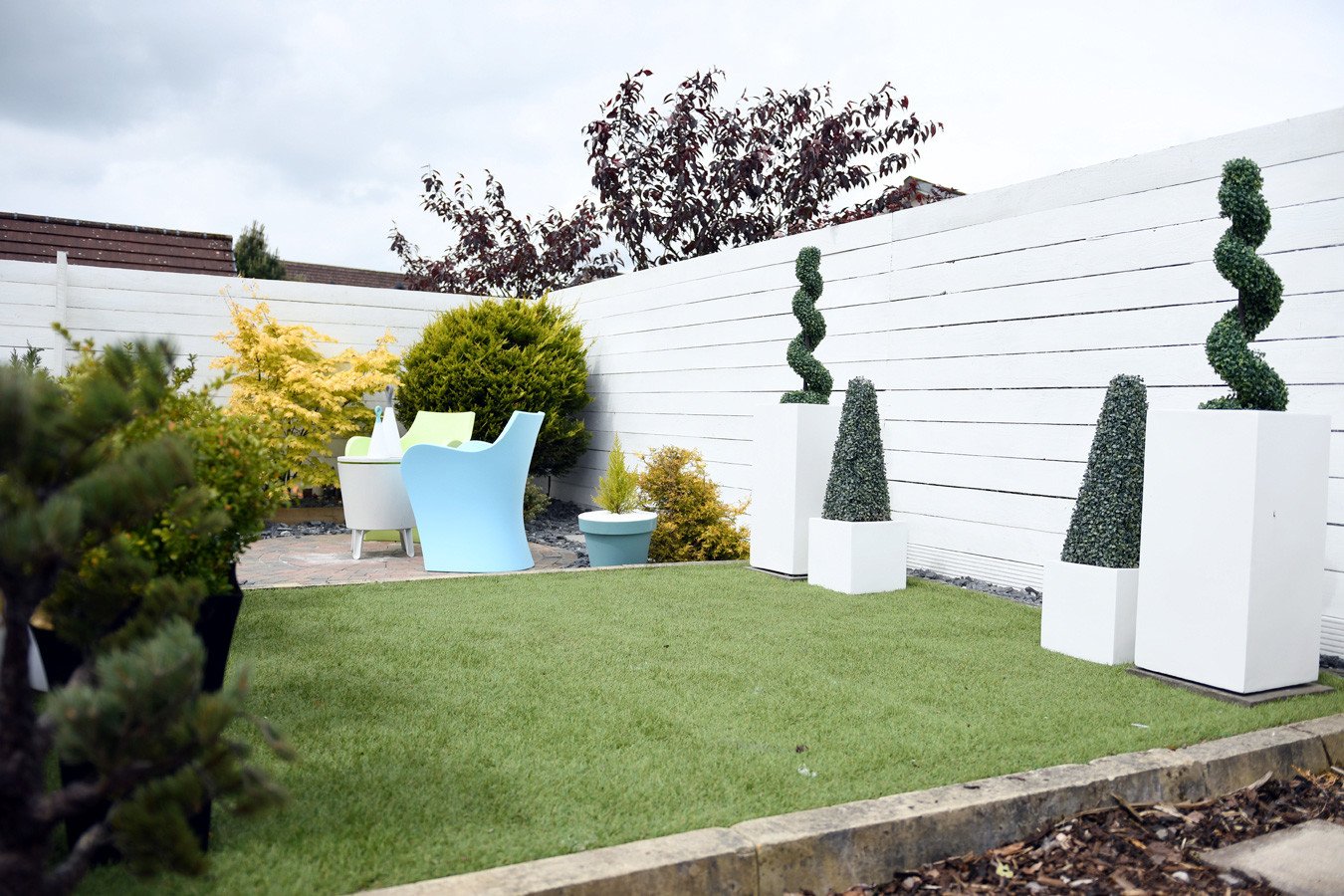 white planter boxes in low maintenance landscaped garden