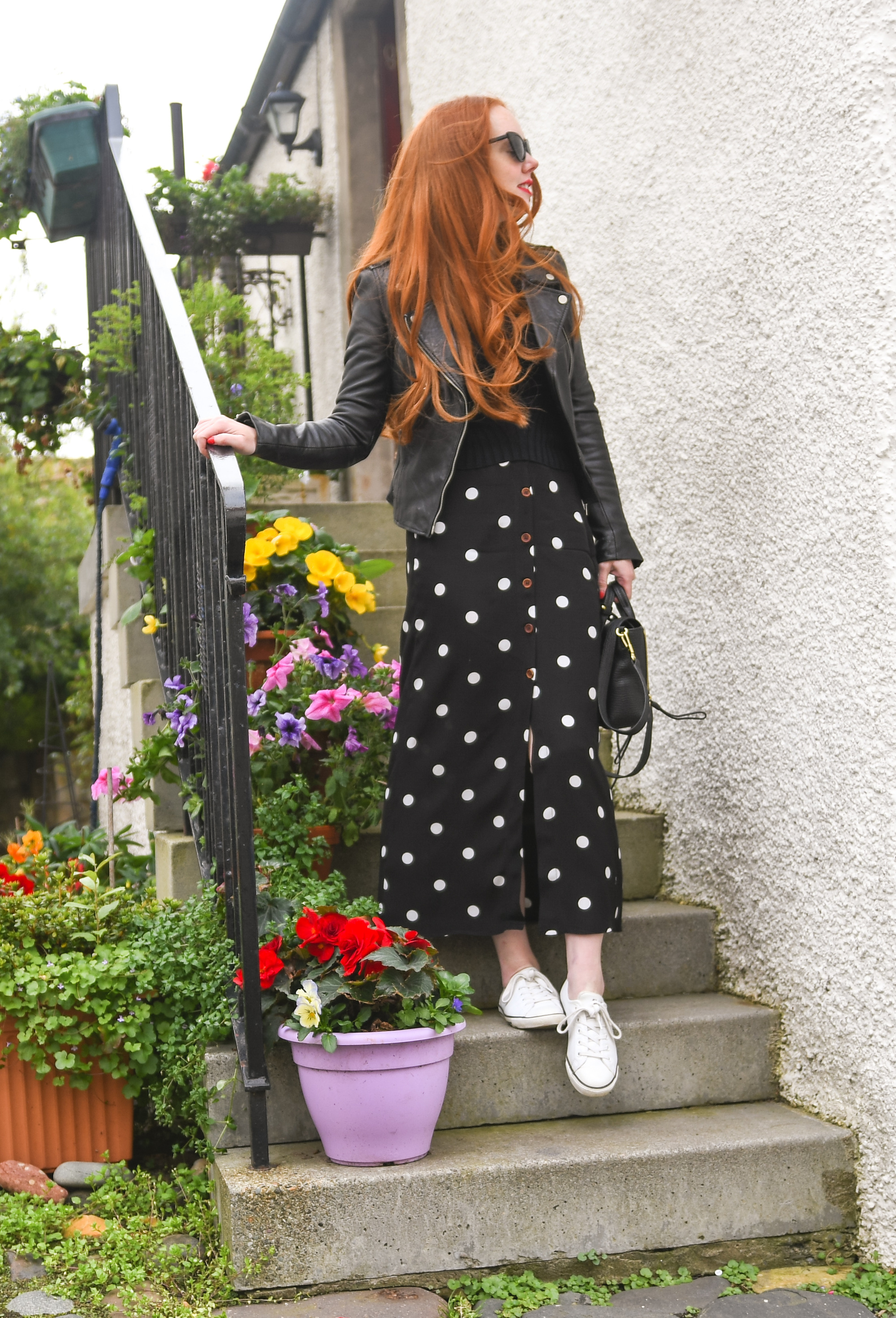 black polka dot maxi skirt with black leather biker jacket and white sneakers