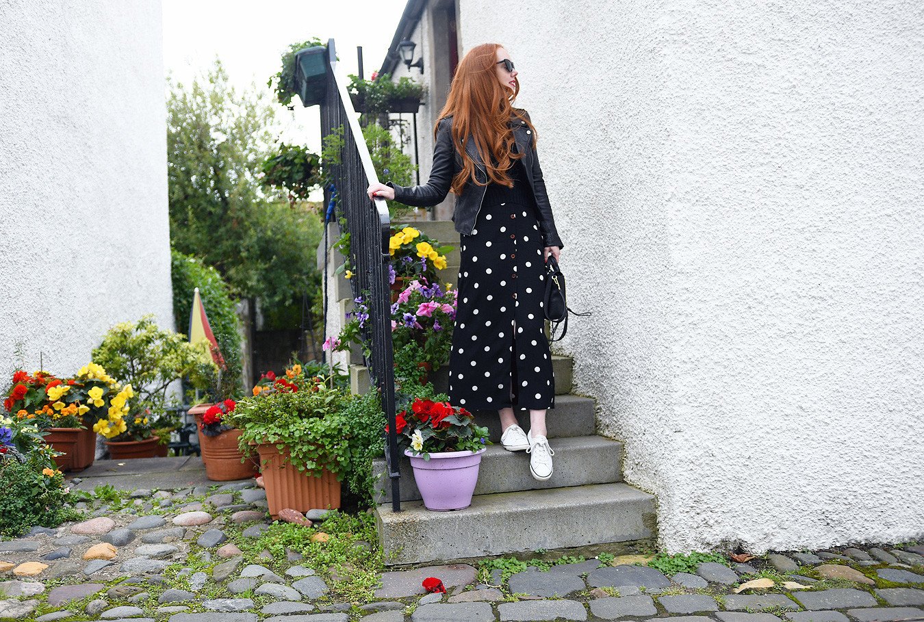 black polka dot maxi skirt with black leather biker jacket and white sneakers