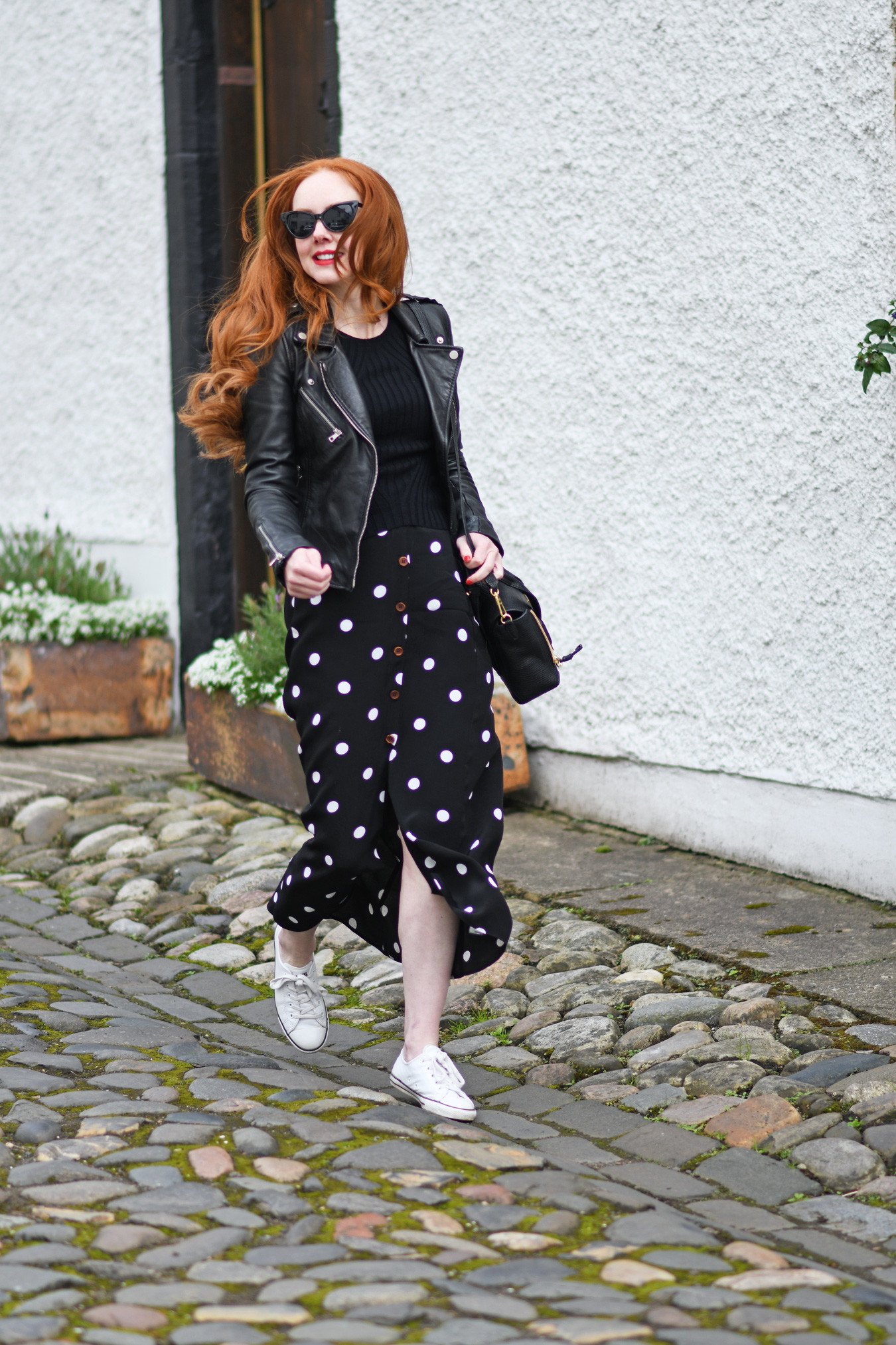 fashion blogger Forever Amber wearing a polka dot maxi skirt with black leather biker jacket