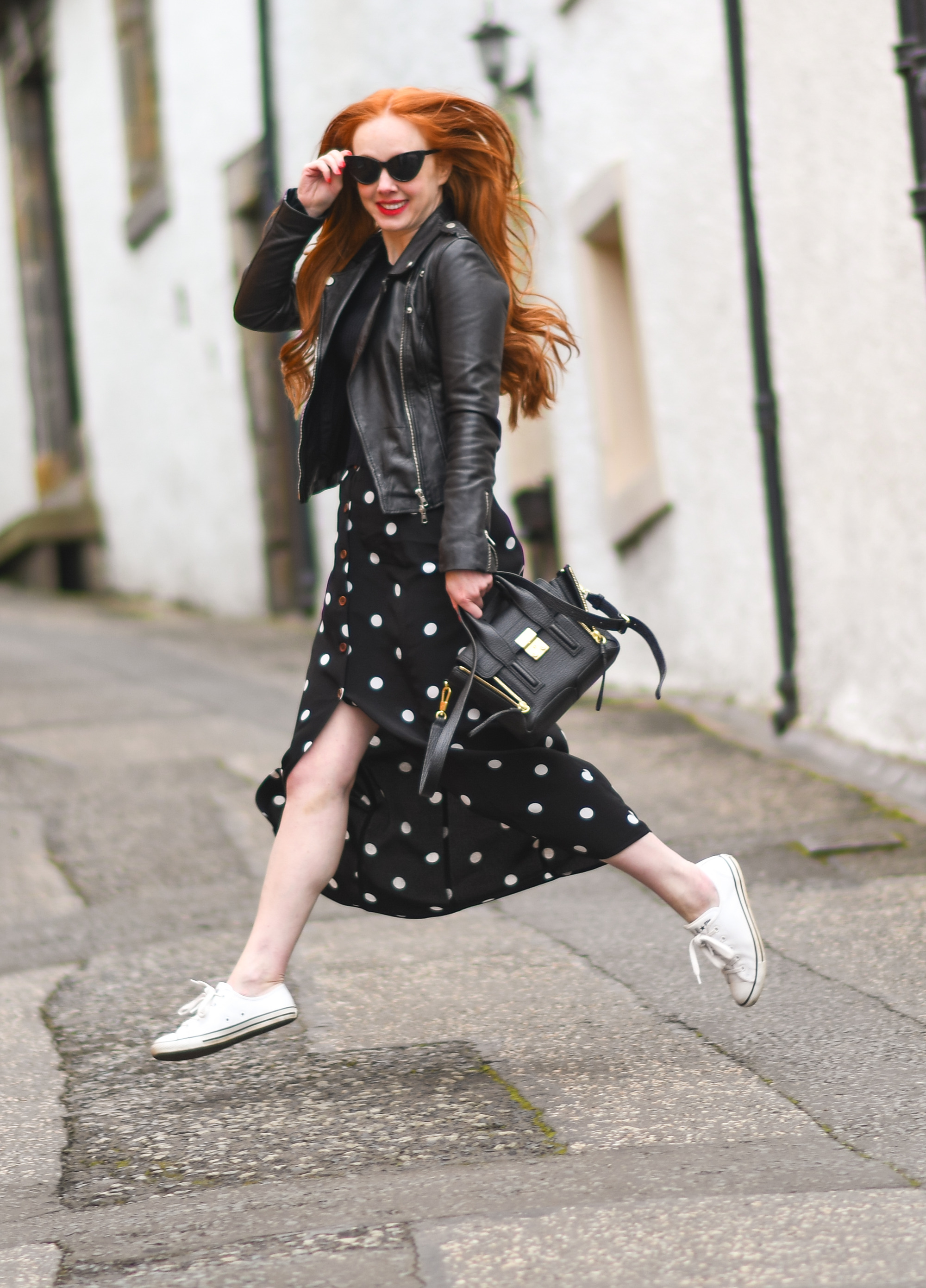 black polka dot maxi skirt with black leather biker jacket and white sneakers