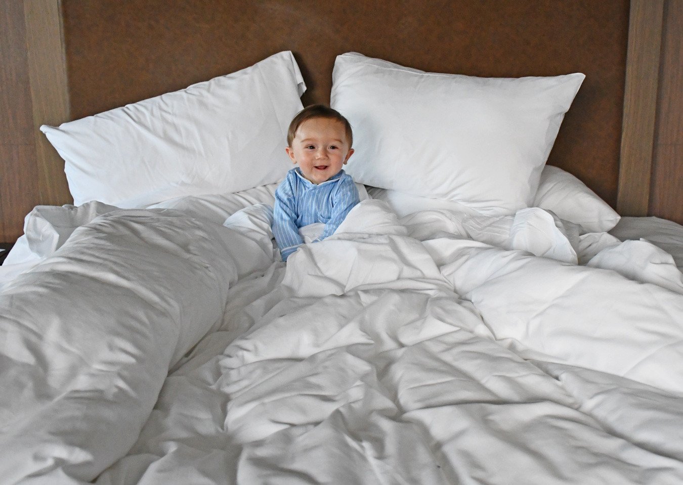 baby in a hotel bed
