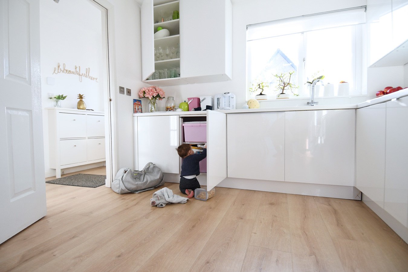 baby rifling through the kitchen cupboards