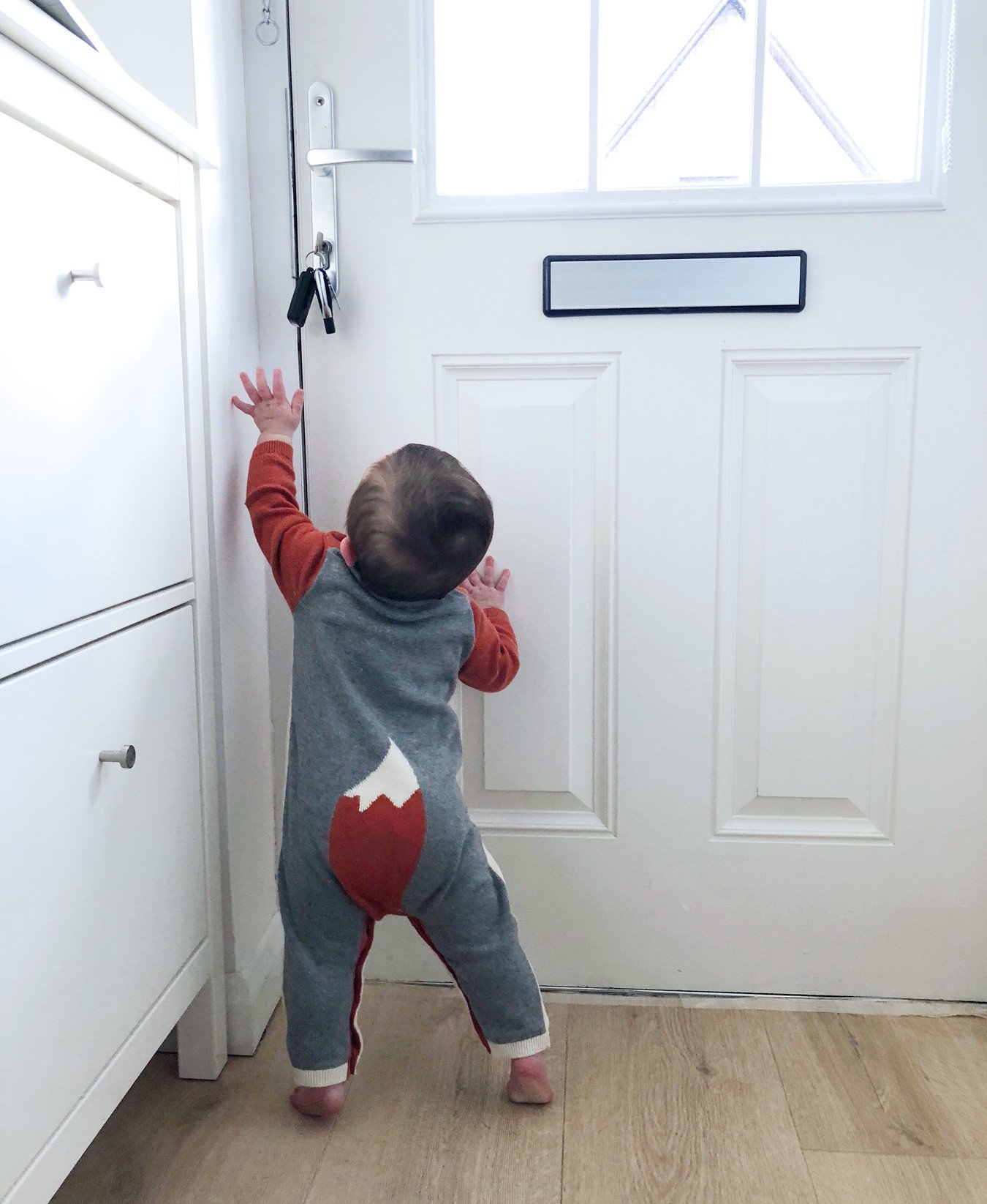 Baby reaching for the door keys