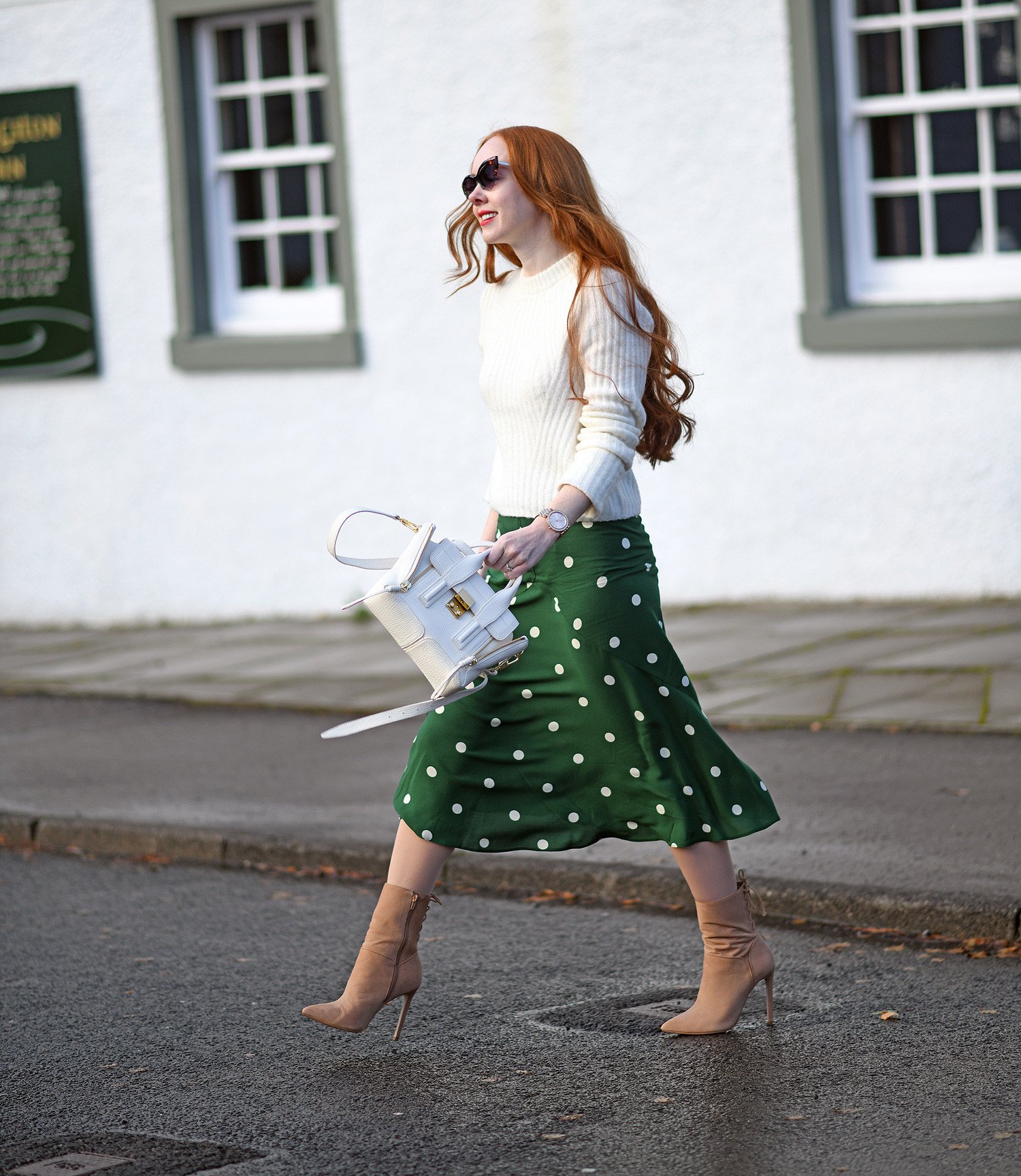 autumn outfit inspiration: grern polka dot skirt with white sweater