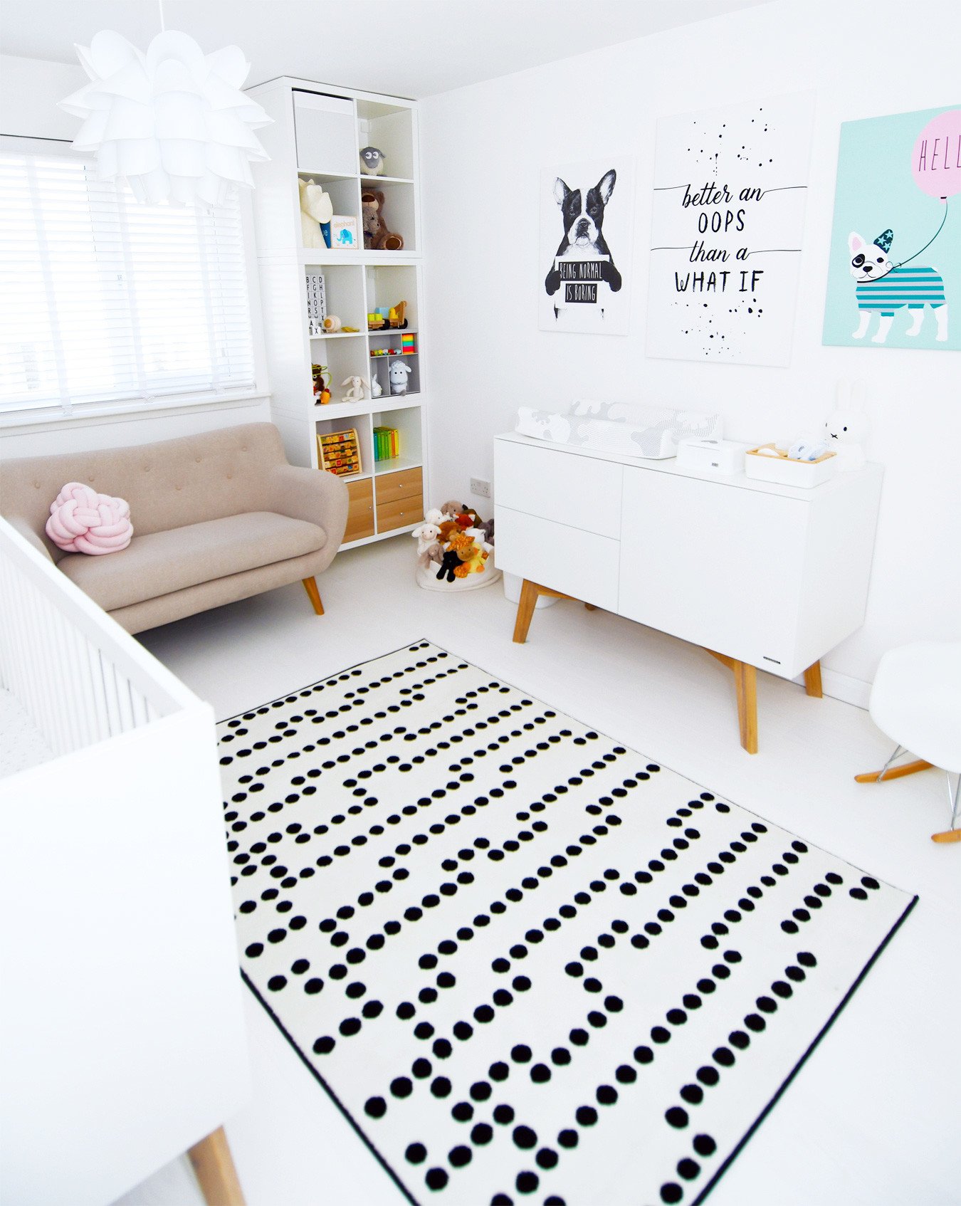 nursery inspiration: baby's nursery with changing table, white floor and colourful artwork