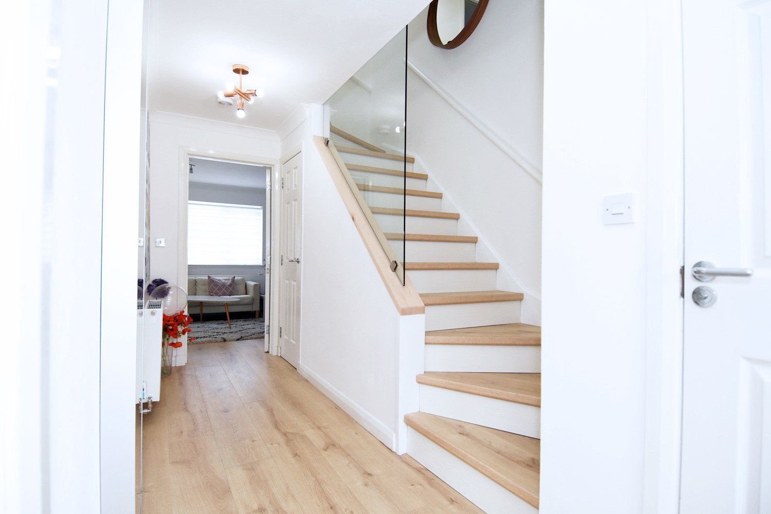 hallway with glass walled staircase