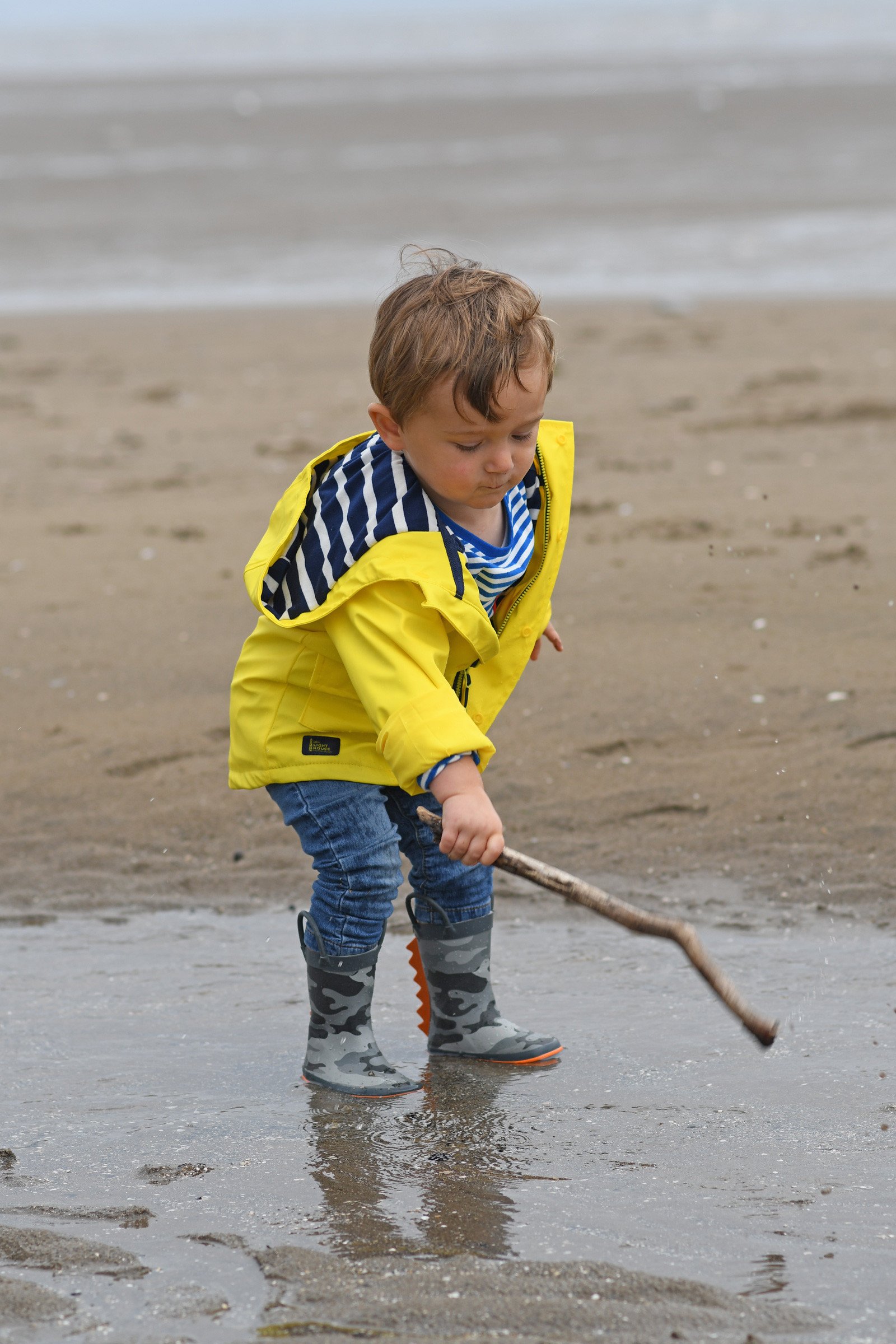 Max in his yellow raincoat on the beach