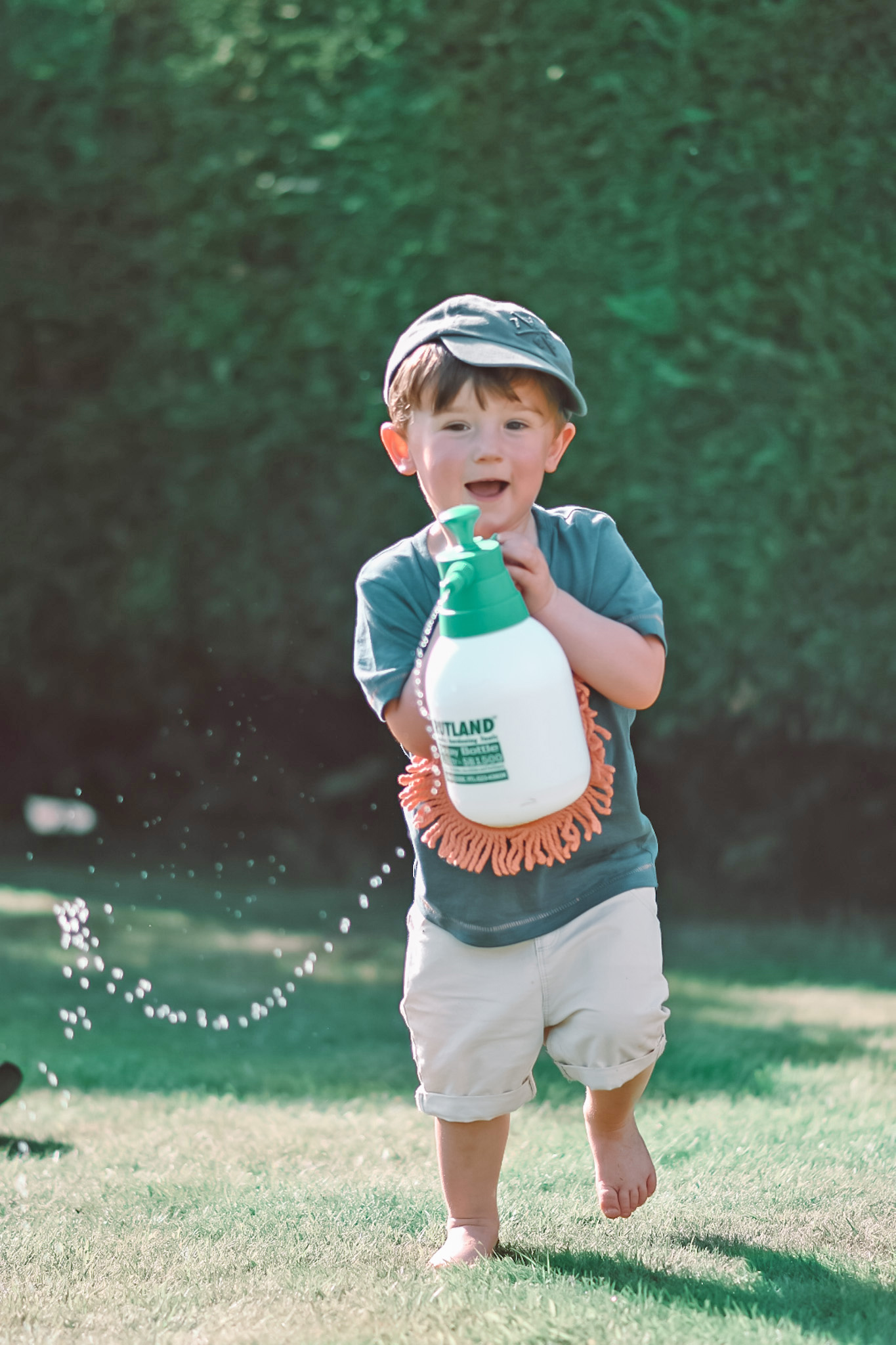 Max playing with a bottle of water in the sun, May 2020