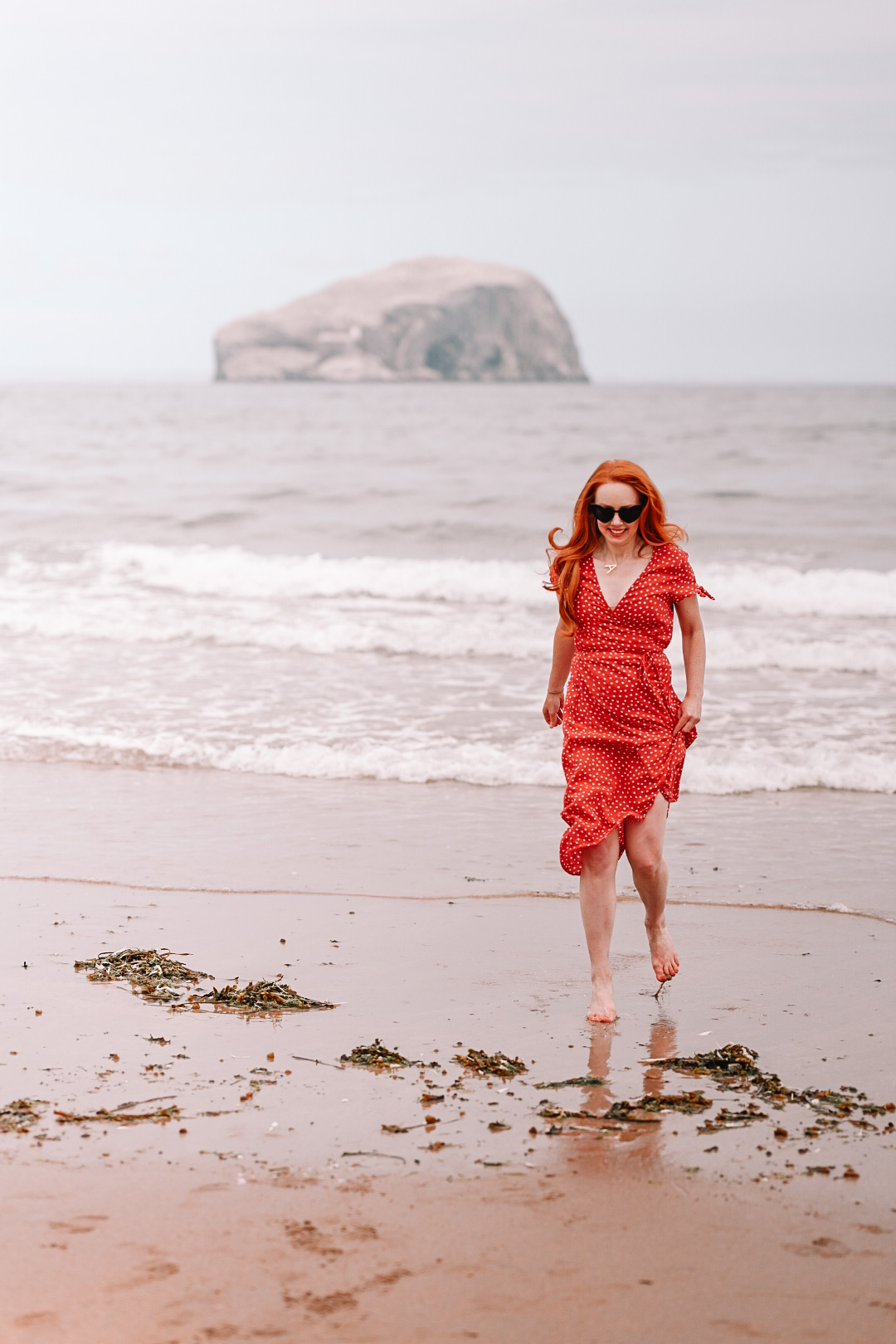 Amber in a red dress on the beach